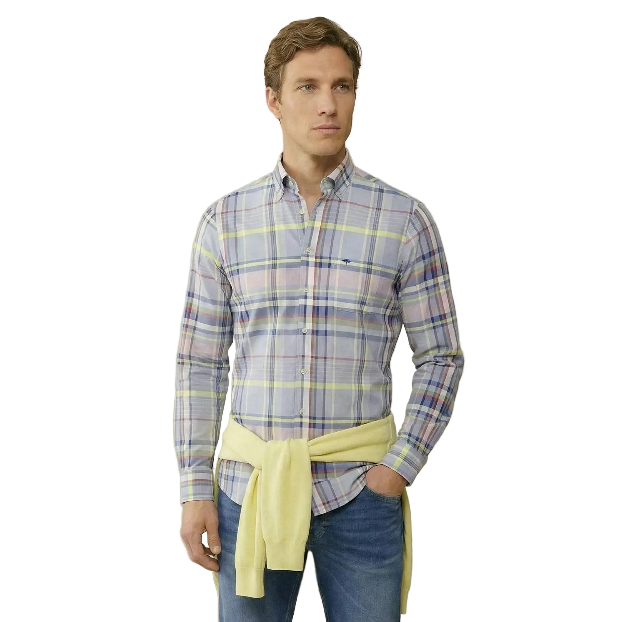 Man wearing a plaid shirt with a yellow tie against a beige background