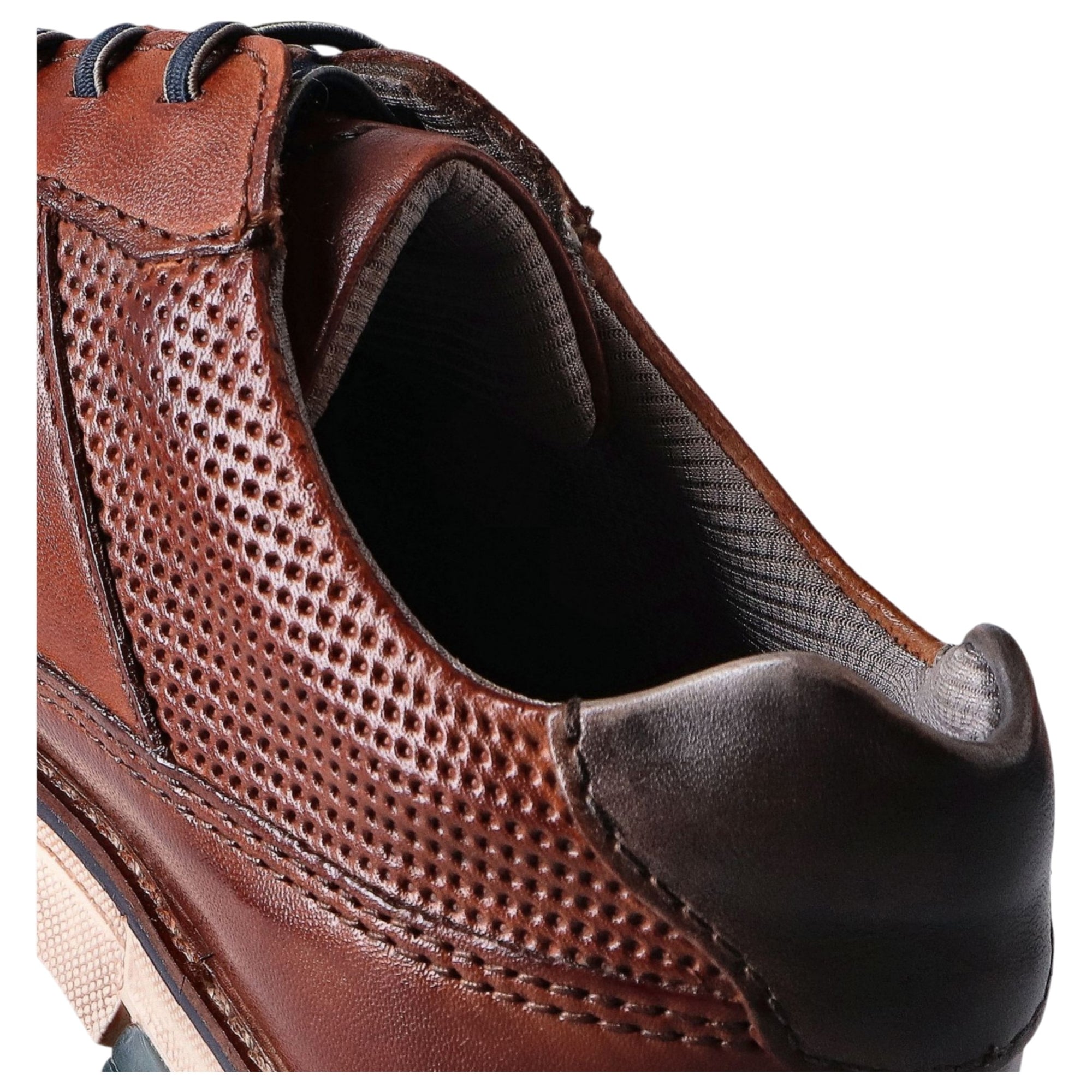 Cognac leather shoe with perforated design on a white background
