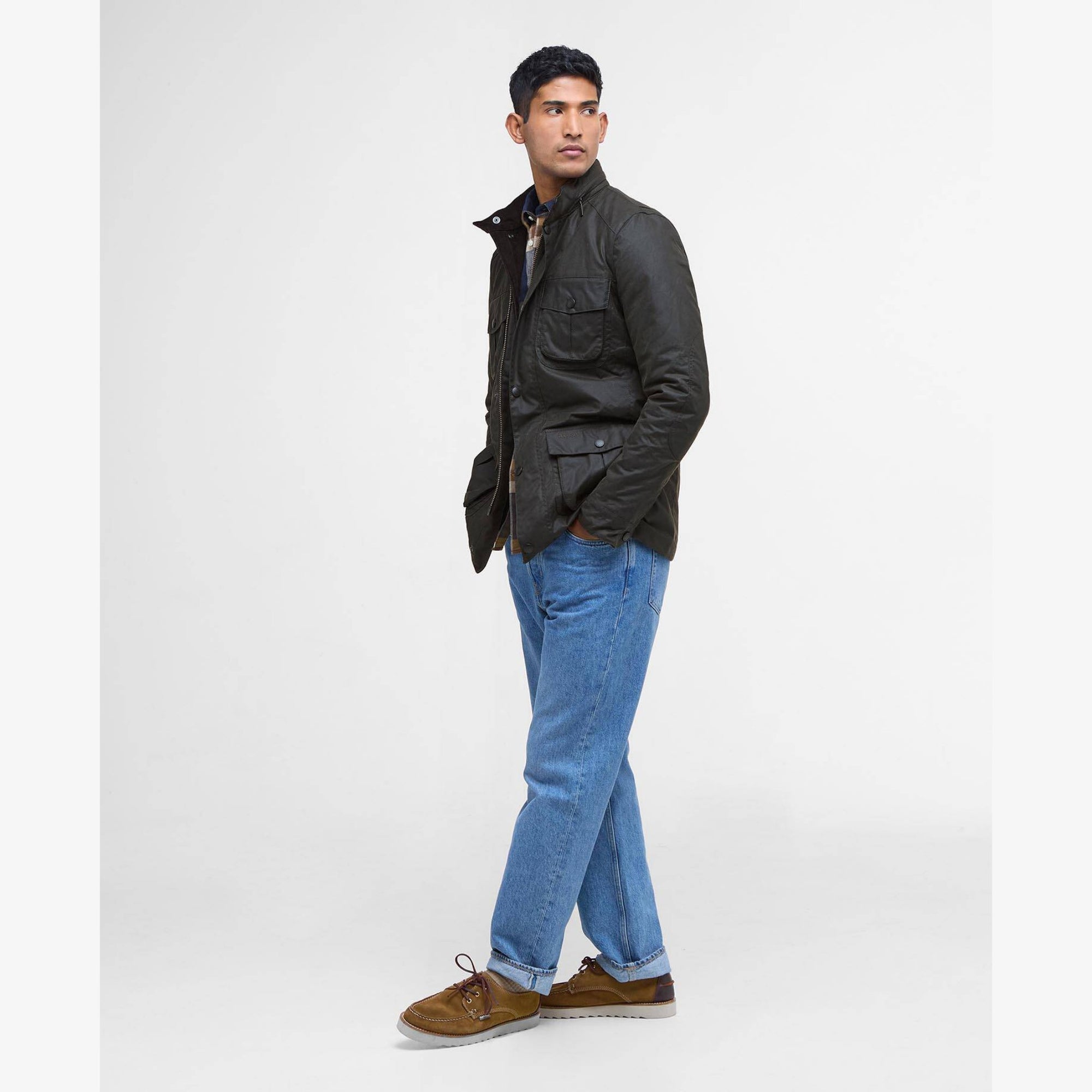 Man wearing a olive Barbour Corbridge jacket with multiple pockets