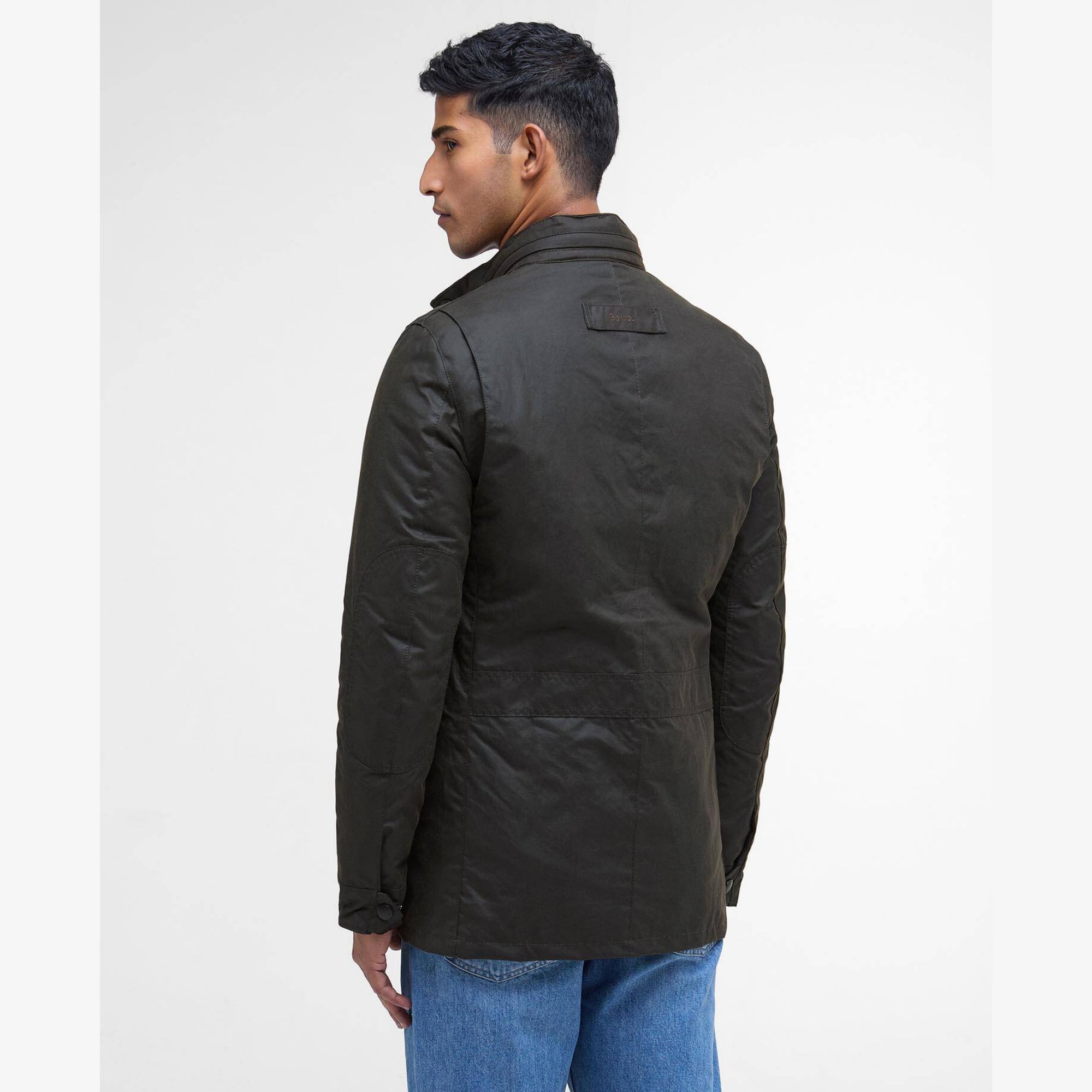 Man wearing a olive Barbour Corbridge jacket with multiple pockets