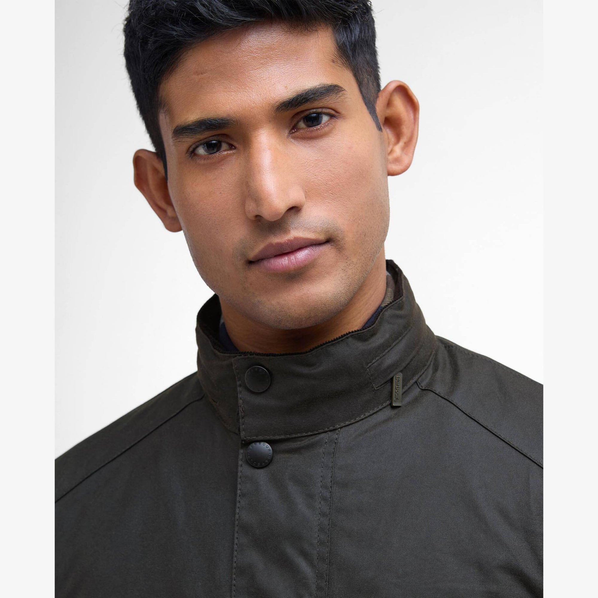 Man wearing a olive Barbour Corbridge jacket with multiple pockets