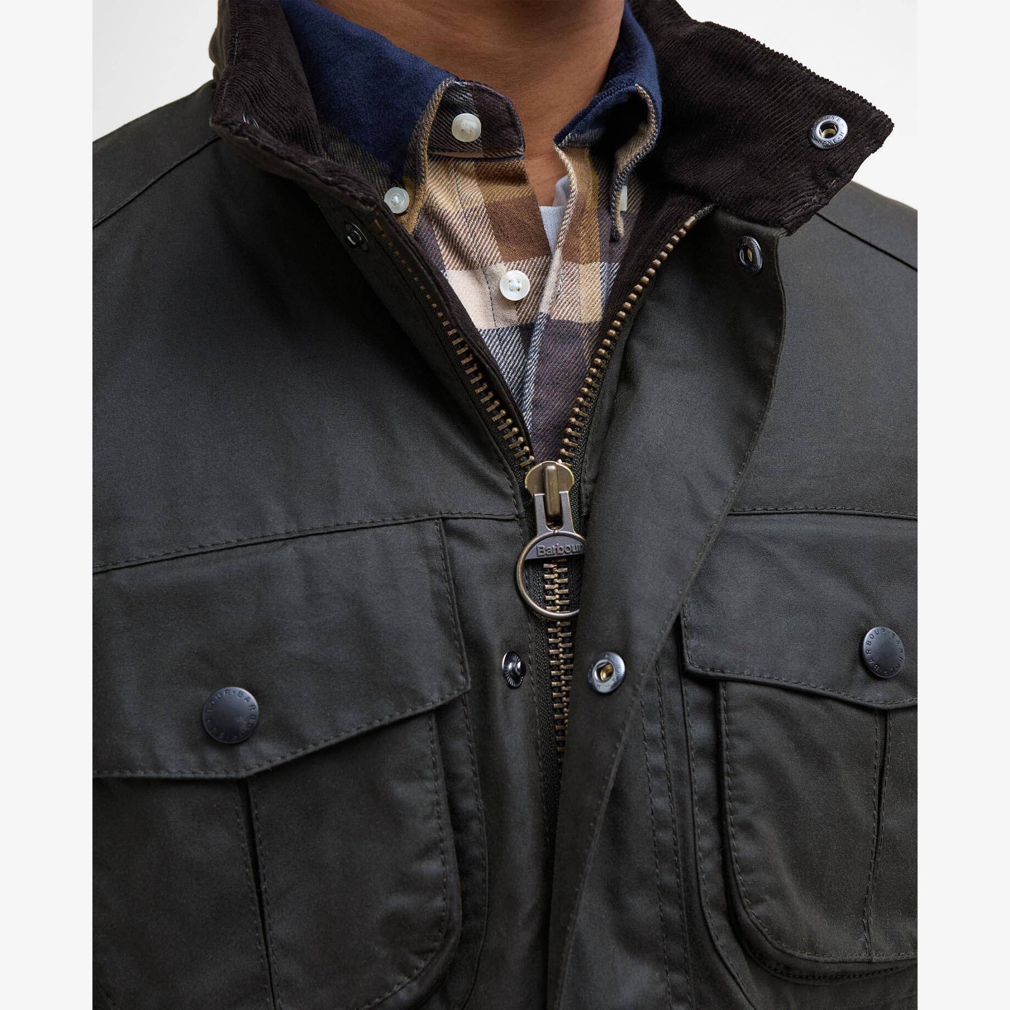 Man wearing a olive Barbour Corbridge jacket with multiple pockets