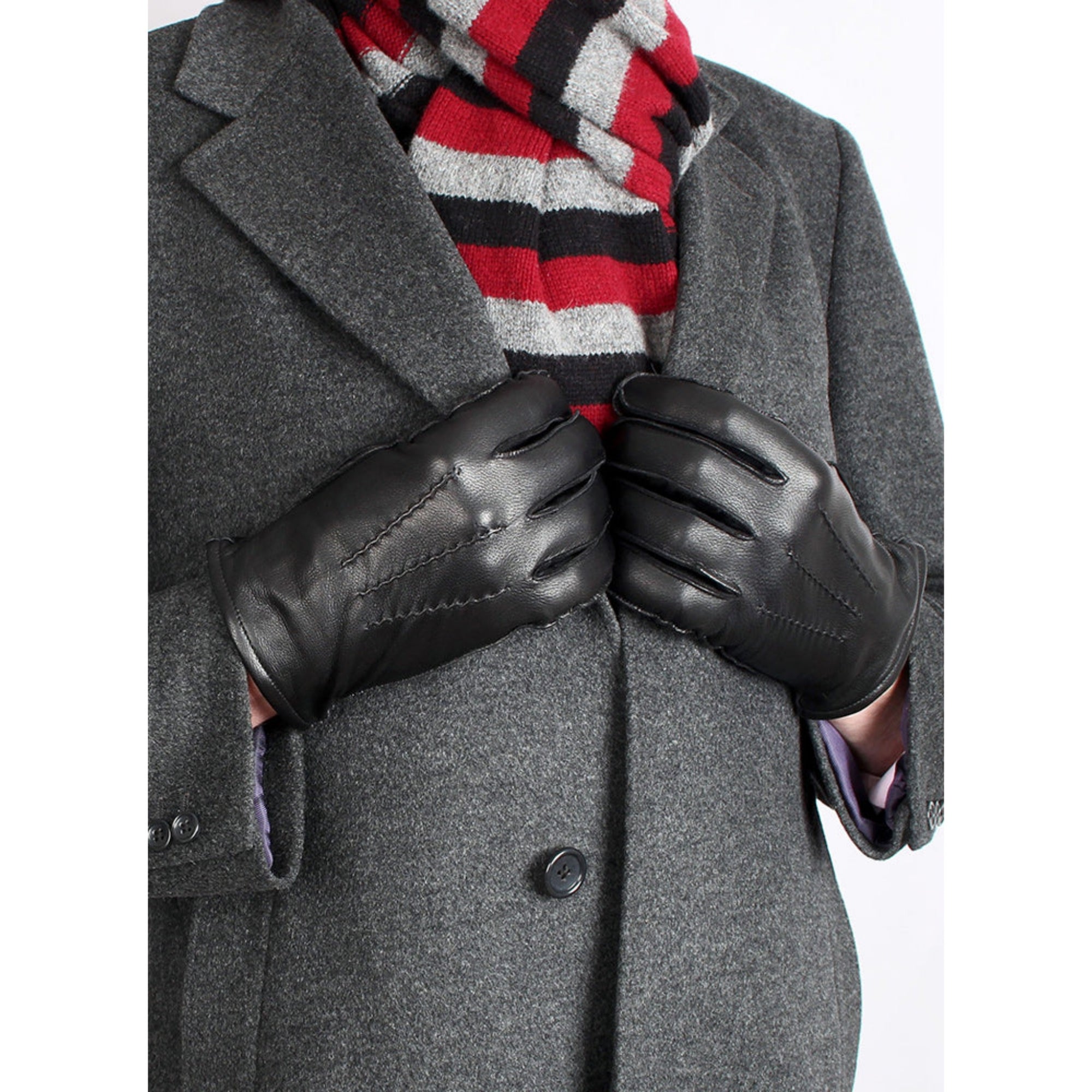 Pair of black leather gloves on a man wearing an overcoat