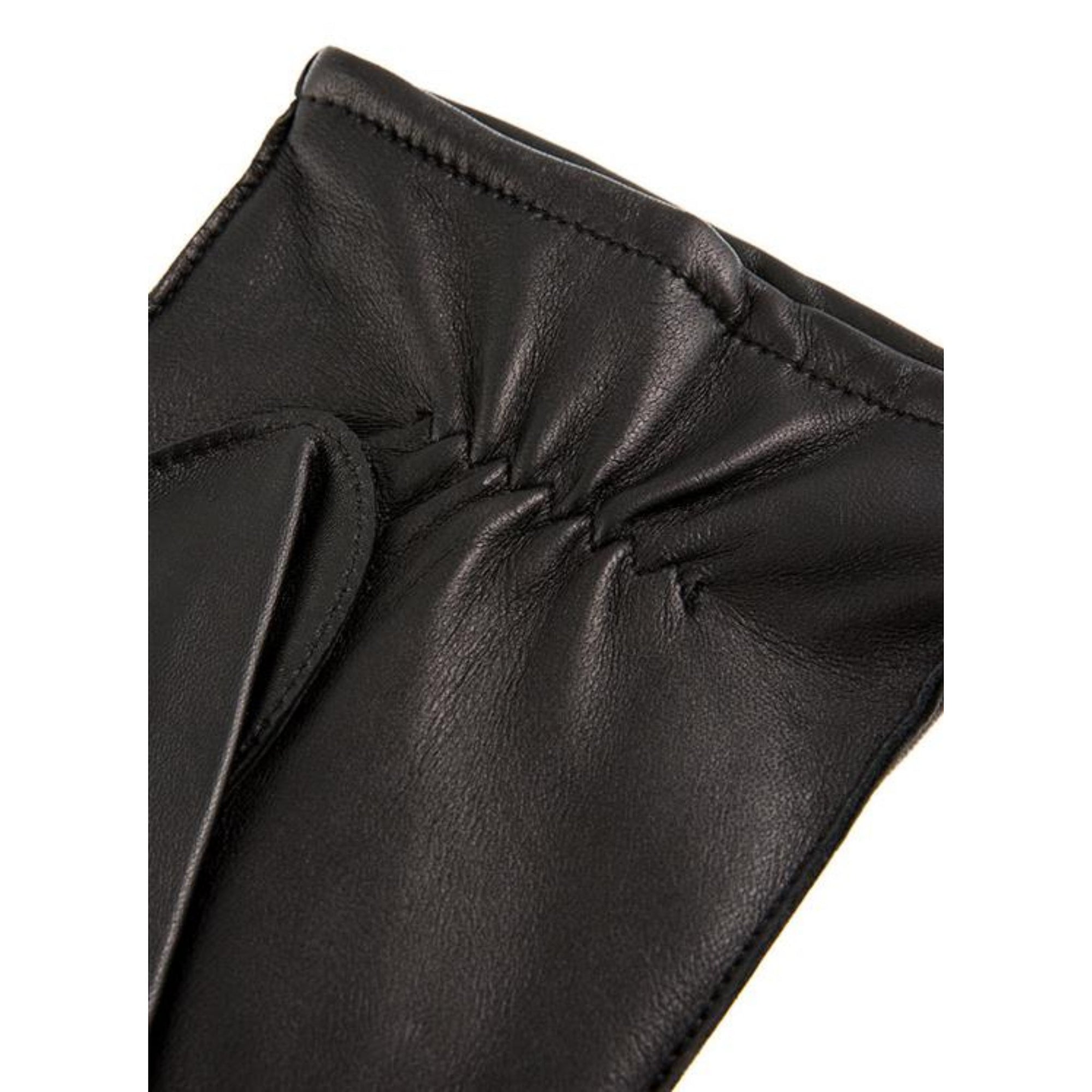 Close-up of a black leather product with a bow detail on a white background