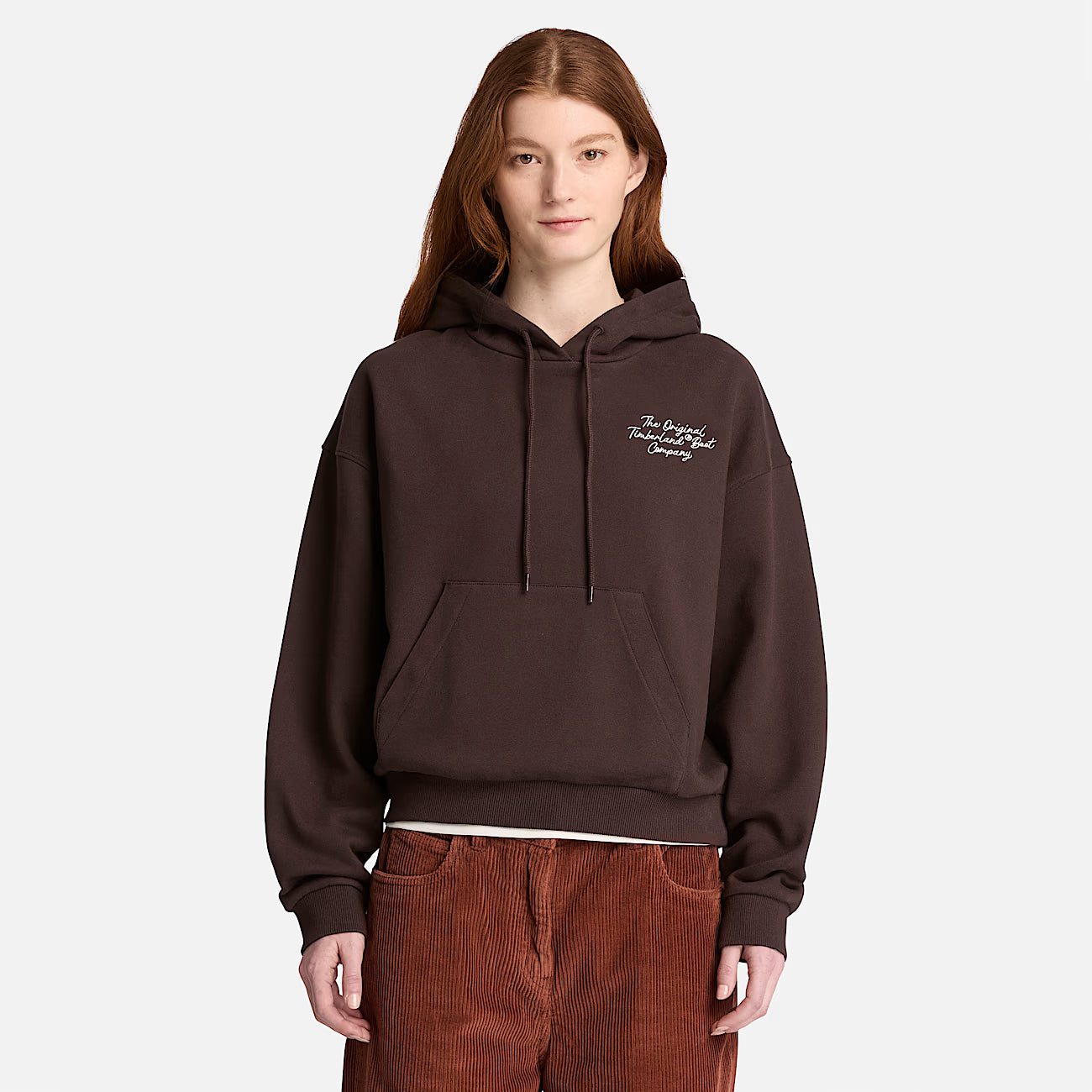 A women wearing a brown Timberland hoodie with text on a white background