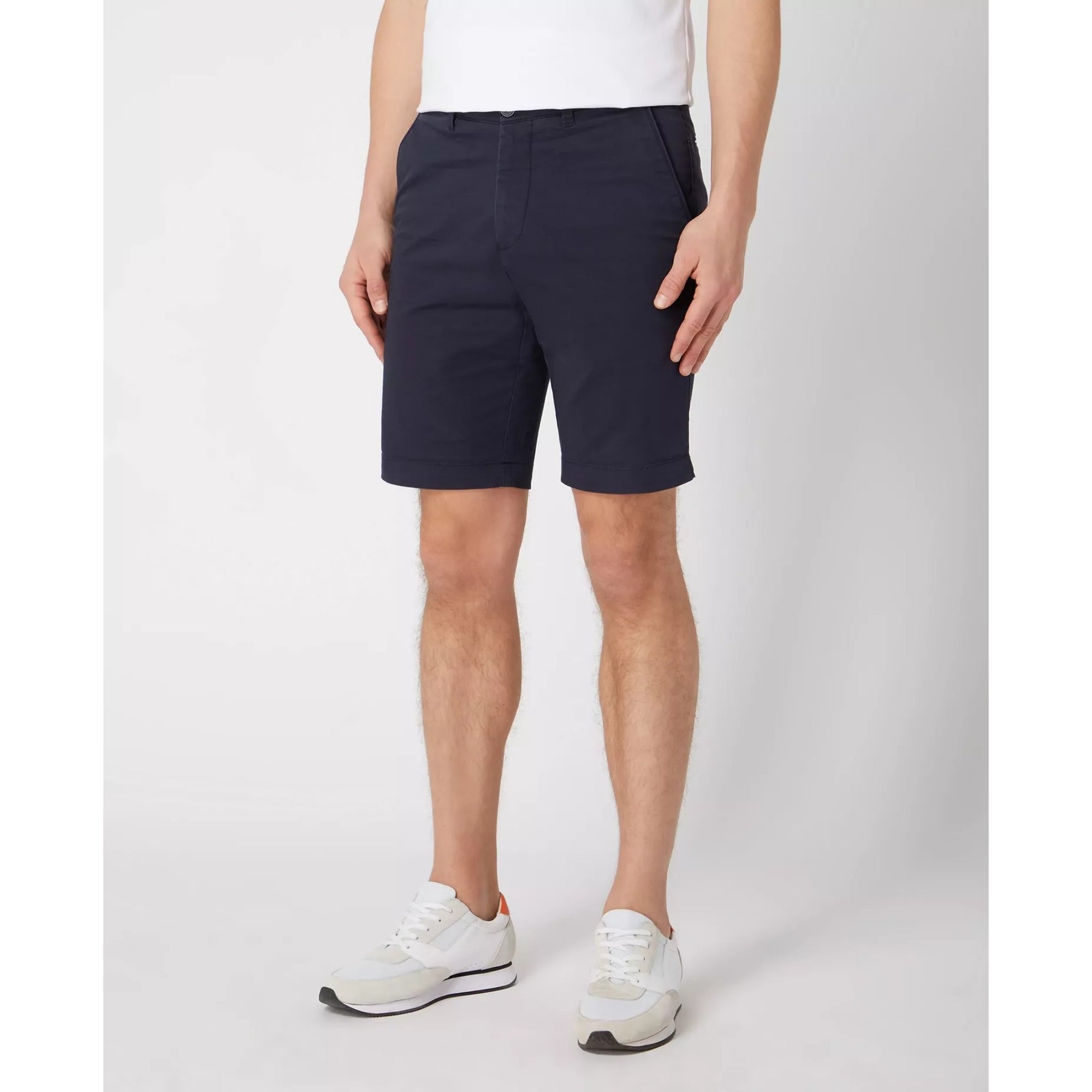 Person wearing navy shorts on a white background