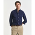 Man wearing a navy GANT button-up shirt and beige pants on a white background