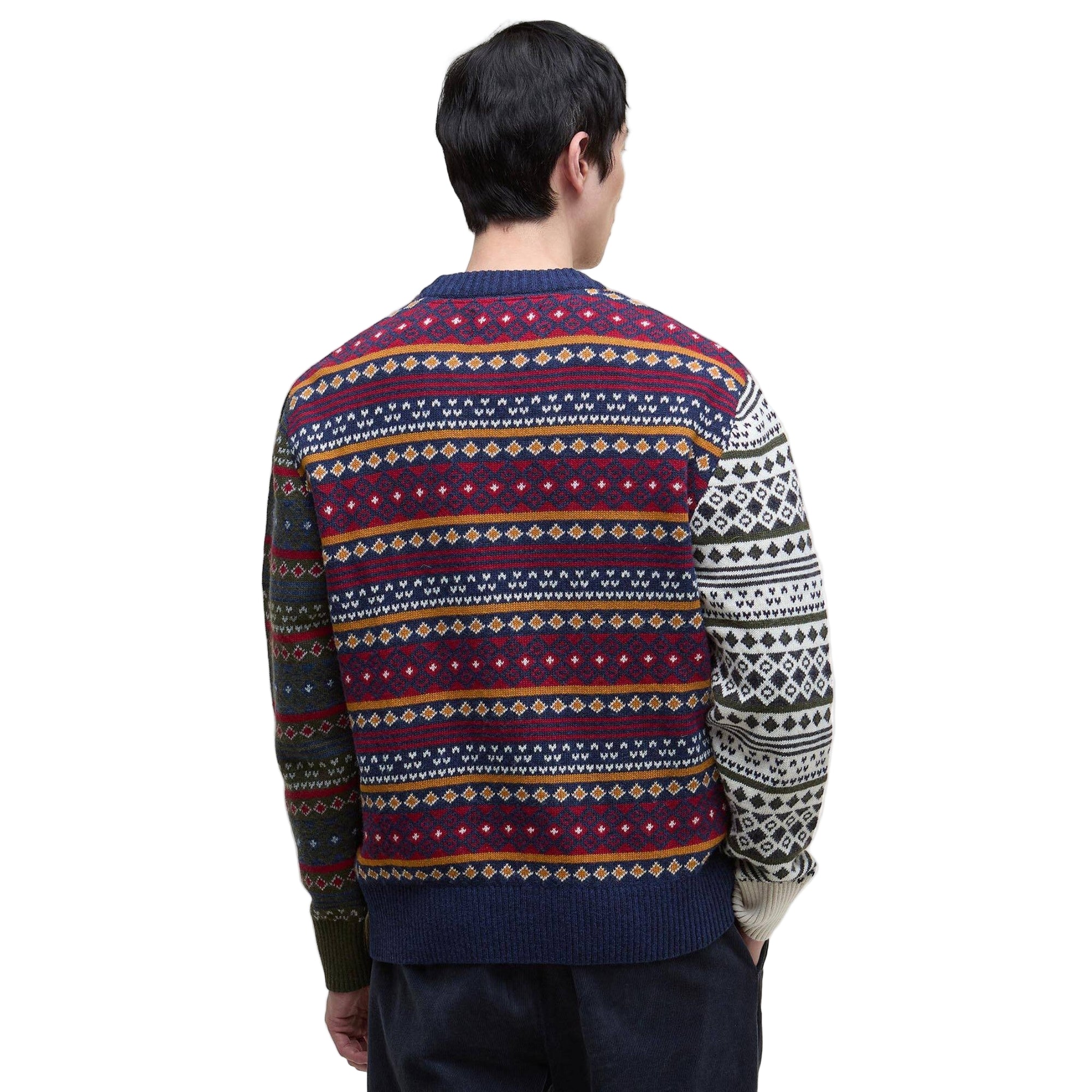 Person wearing a patterned sweater on a white background