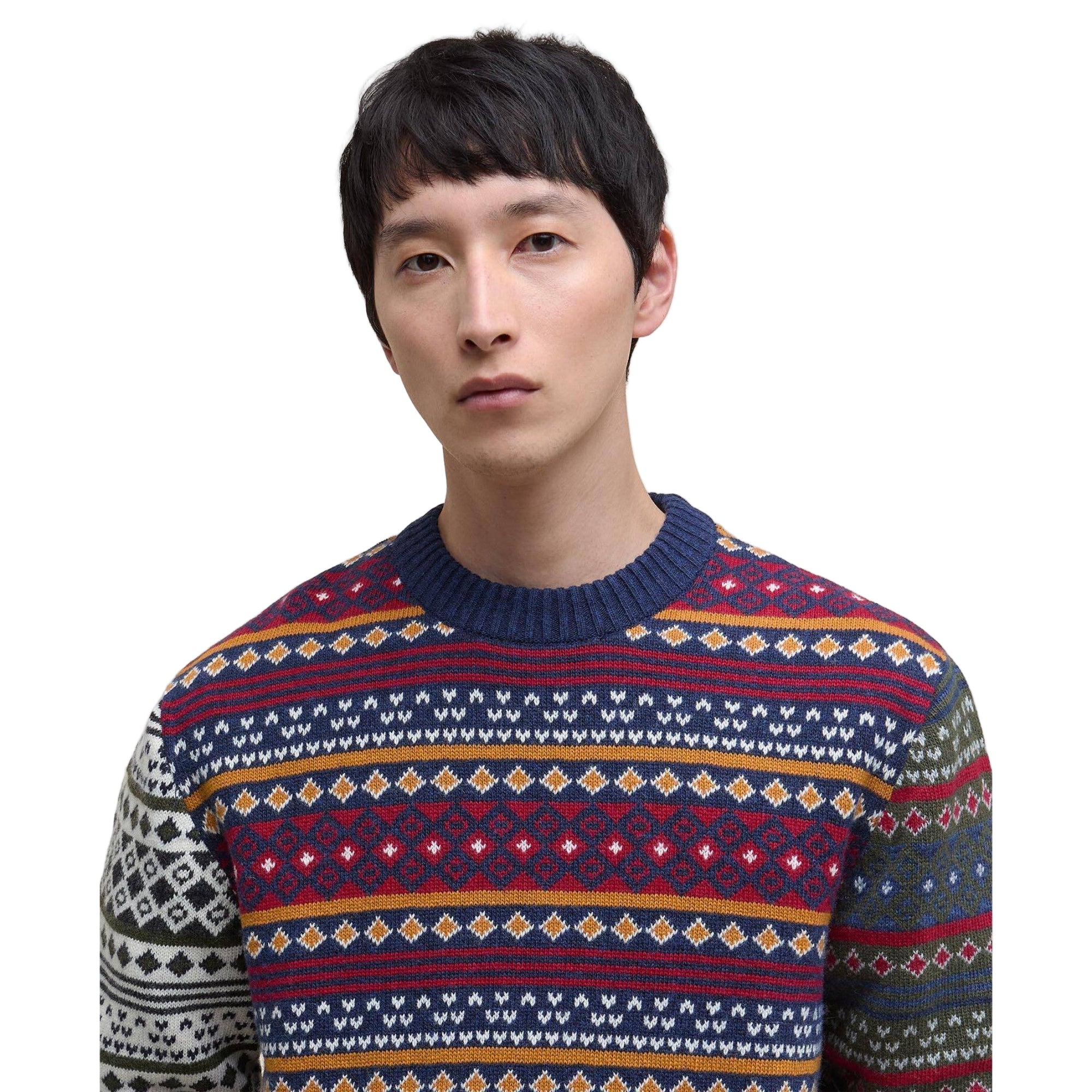 Person wearing a colorful patterned sweater against a white background