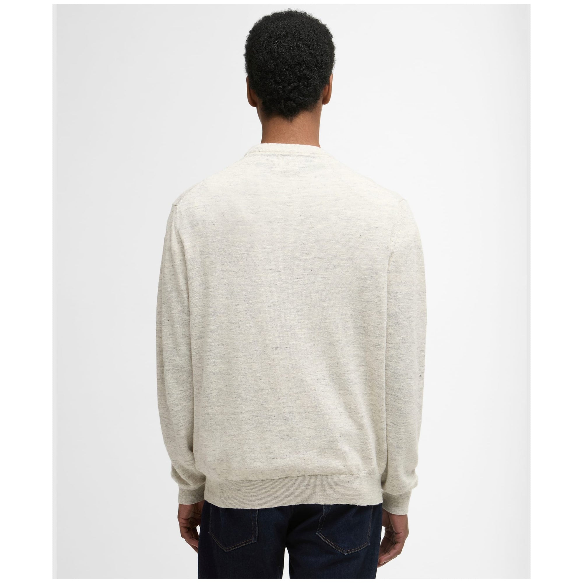 Person wearing a beige sweater from behind on a white background
