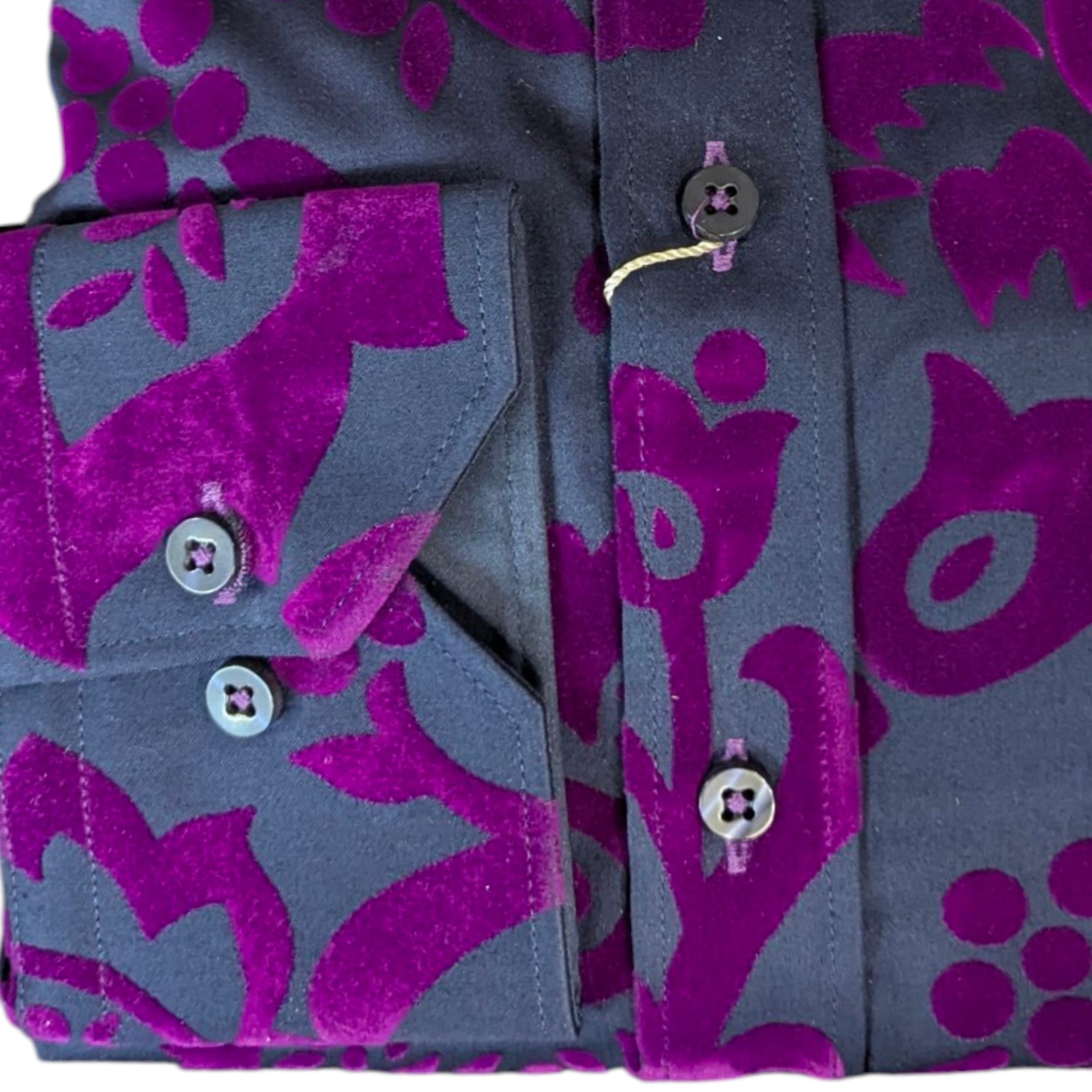 Close-up of a shirt with purple floral pattern on gray background