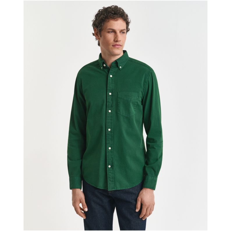 Man wearing a GANT green shirt on a white background