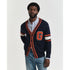 Man wearing a GANT navy blue cardigan with orange accents and a large 'G' on a light gray background