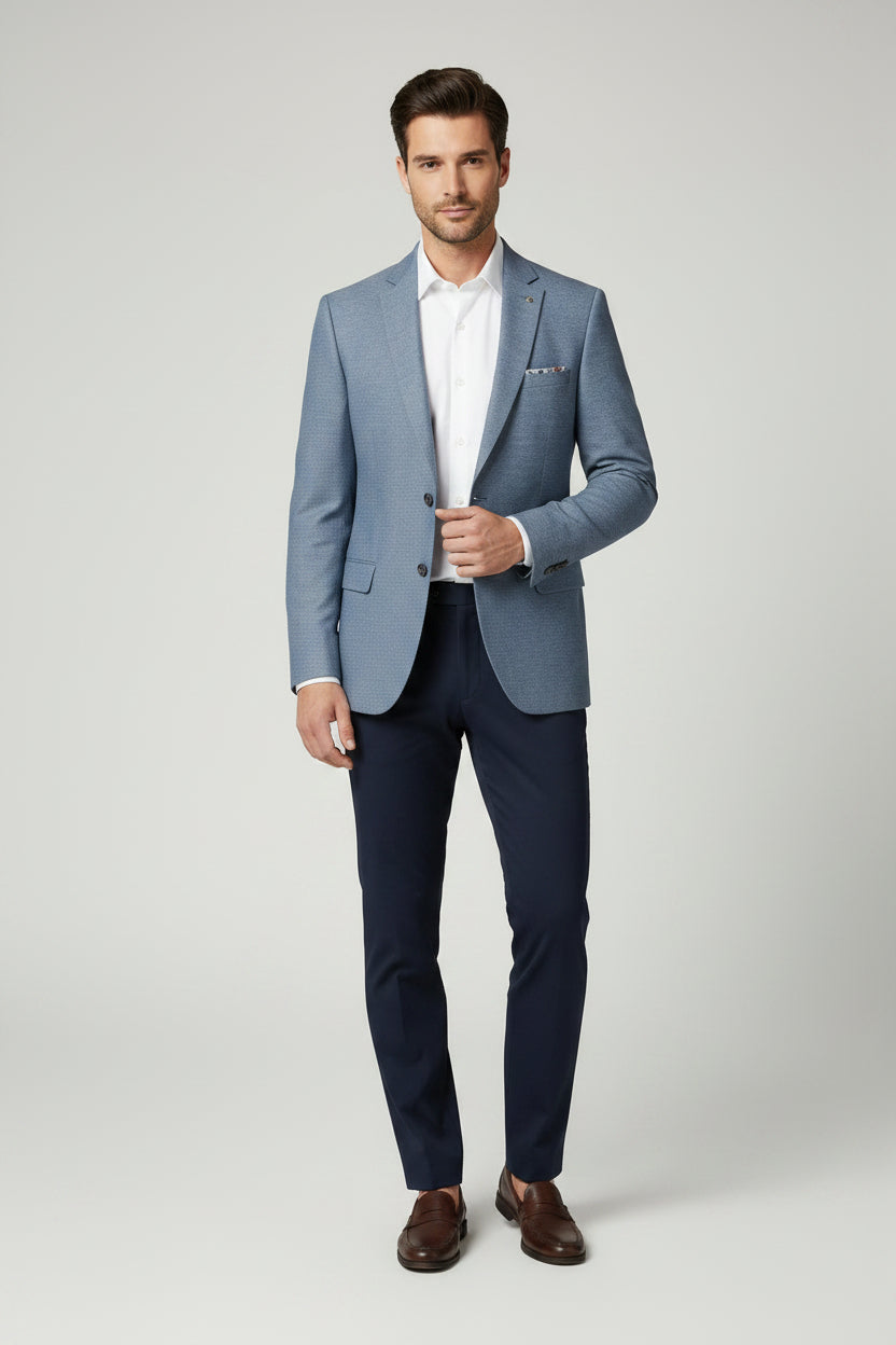 Blue blazer with floral lining and colorful buttons on a white background