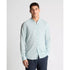 Man wearing a light blue button-up shirt against a white background