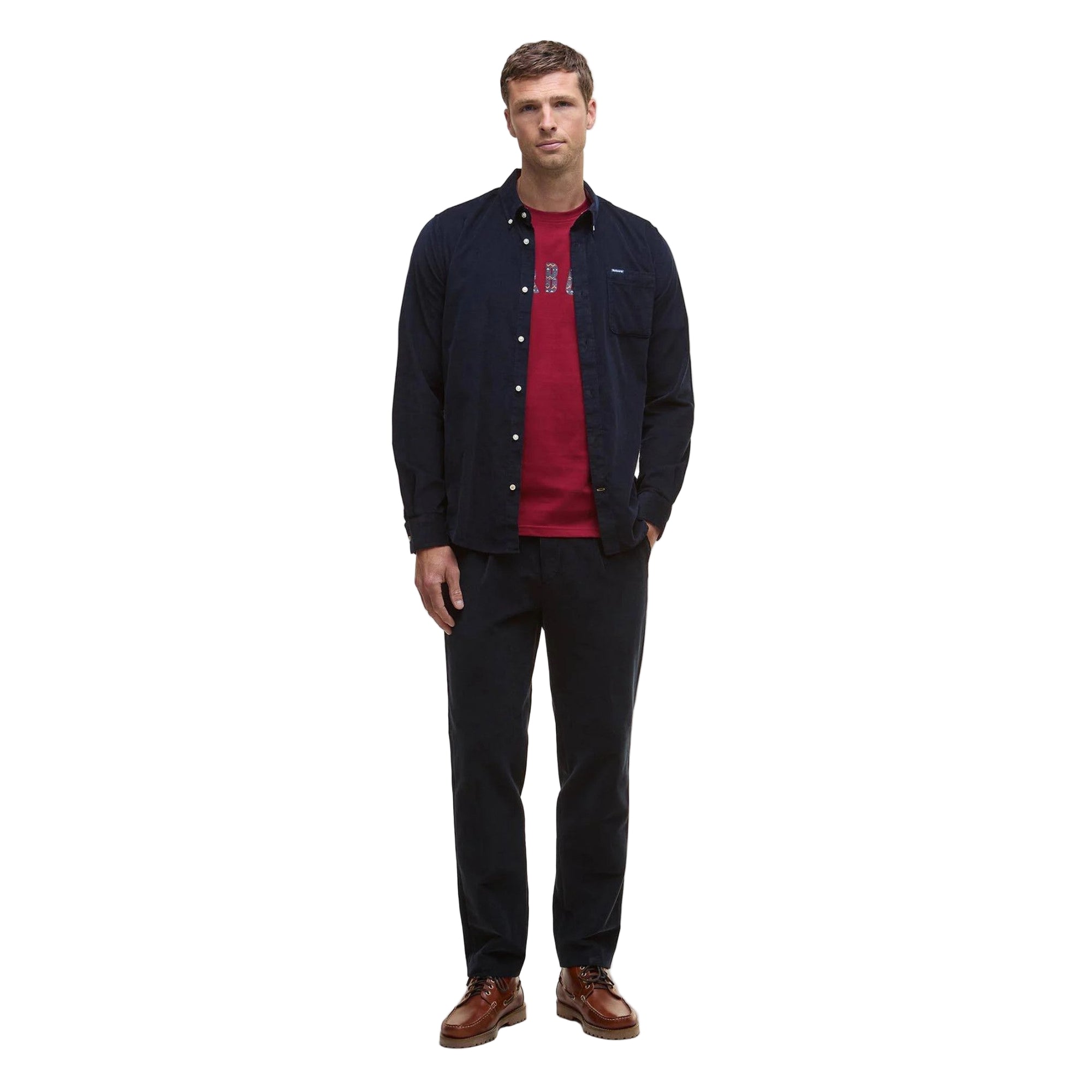 Man wearing a navy jacket, red shirt, black pants, and brown shoes on a white background