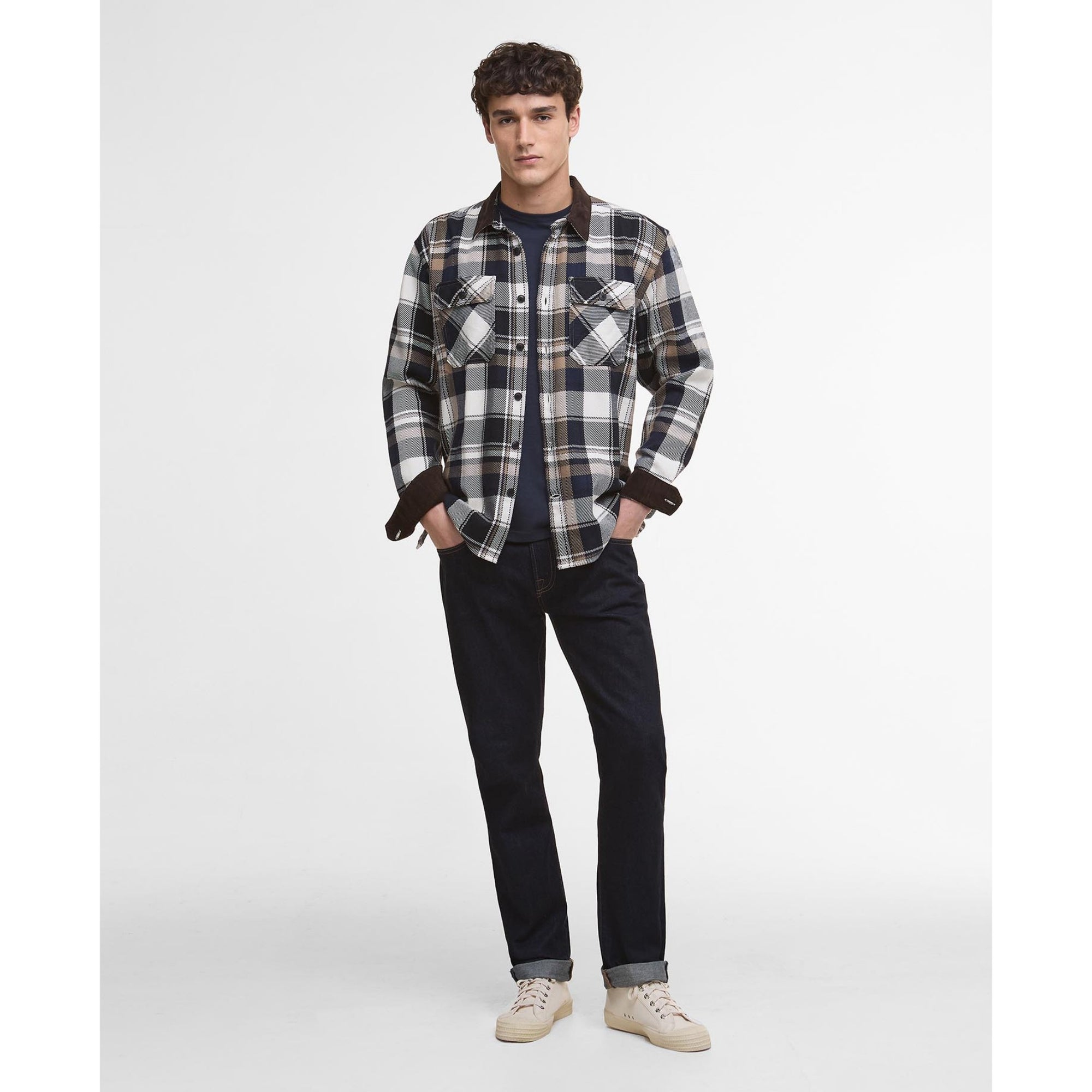 Man wearing a Barbour plaid shirt with a white background