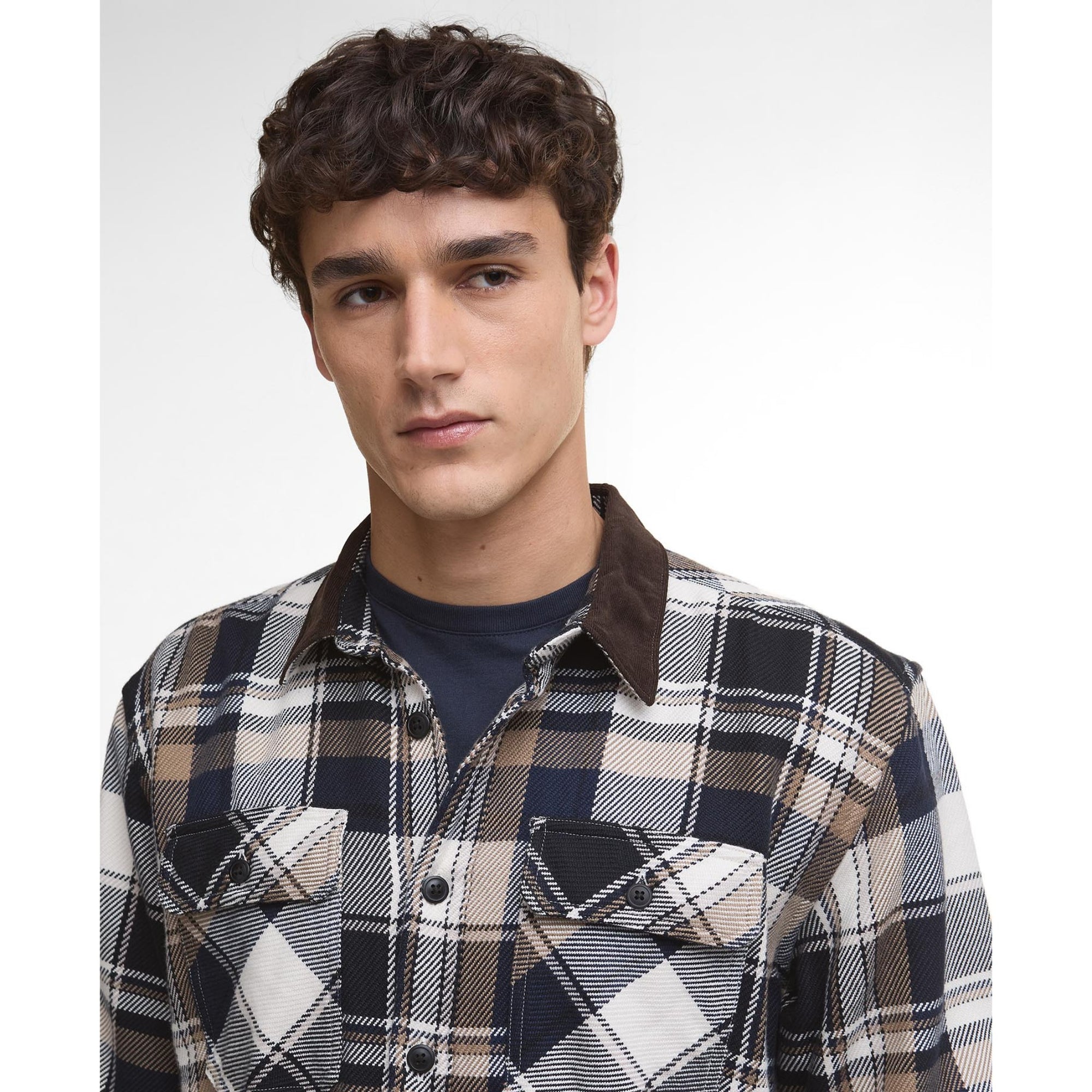Man wearing a Barbour plaid shirt with a white background
