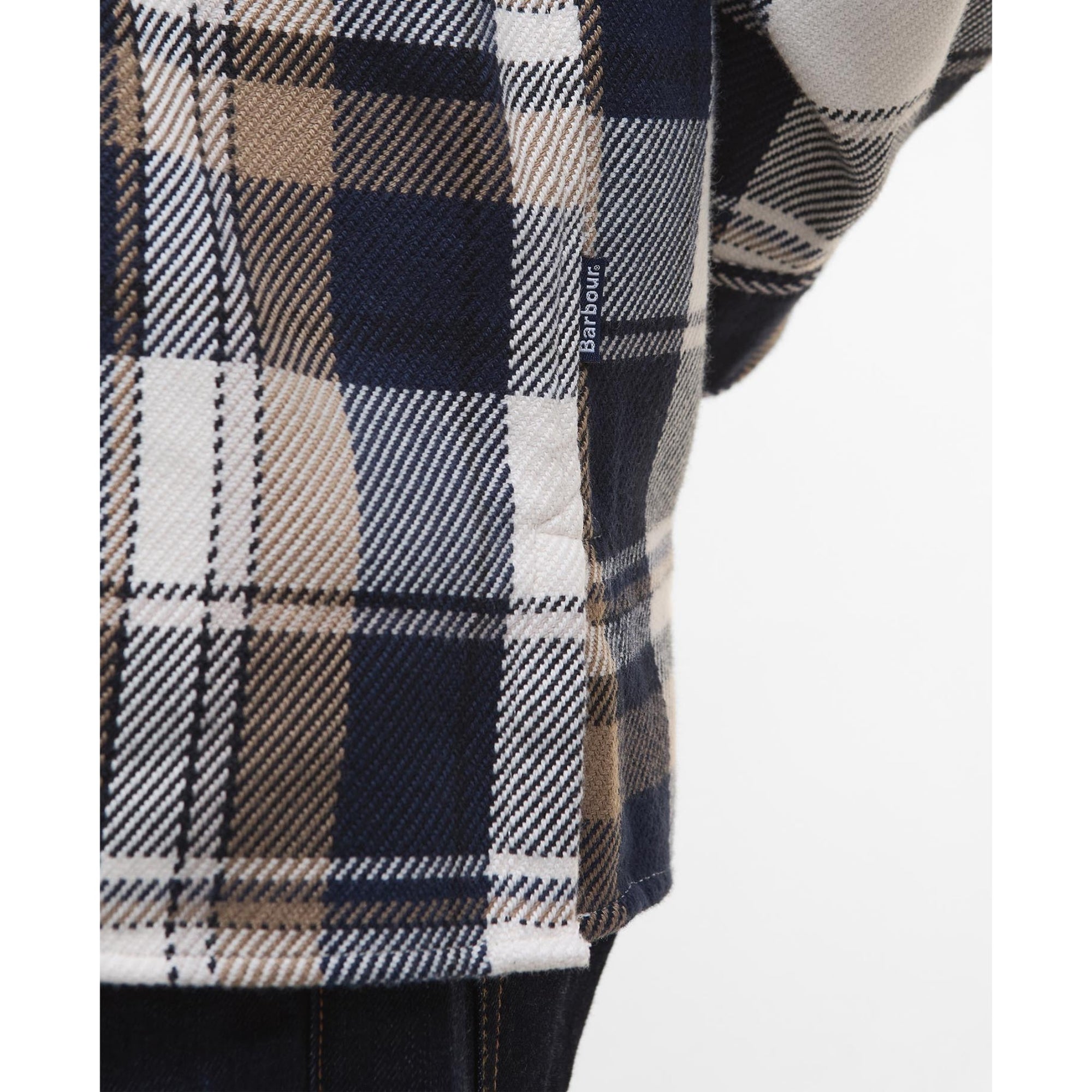 Man wearing a Barbour plaid shirt with a white background