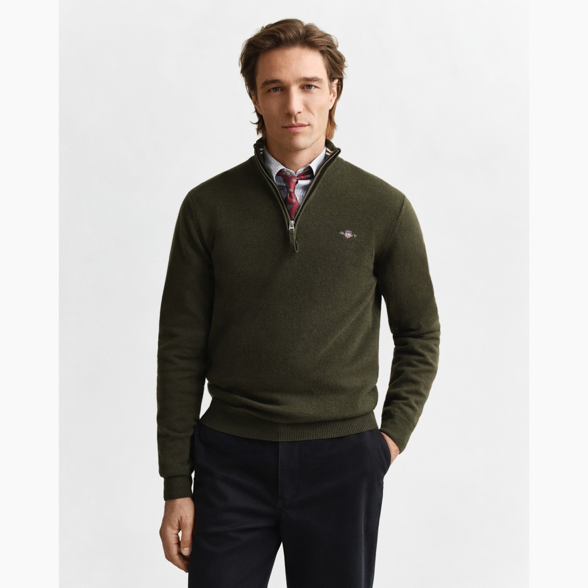 Man wearing a green half-zip sweater with a visible GANT logo