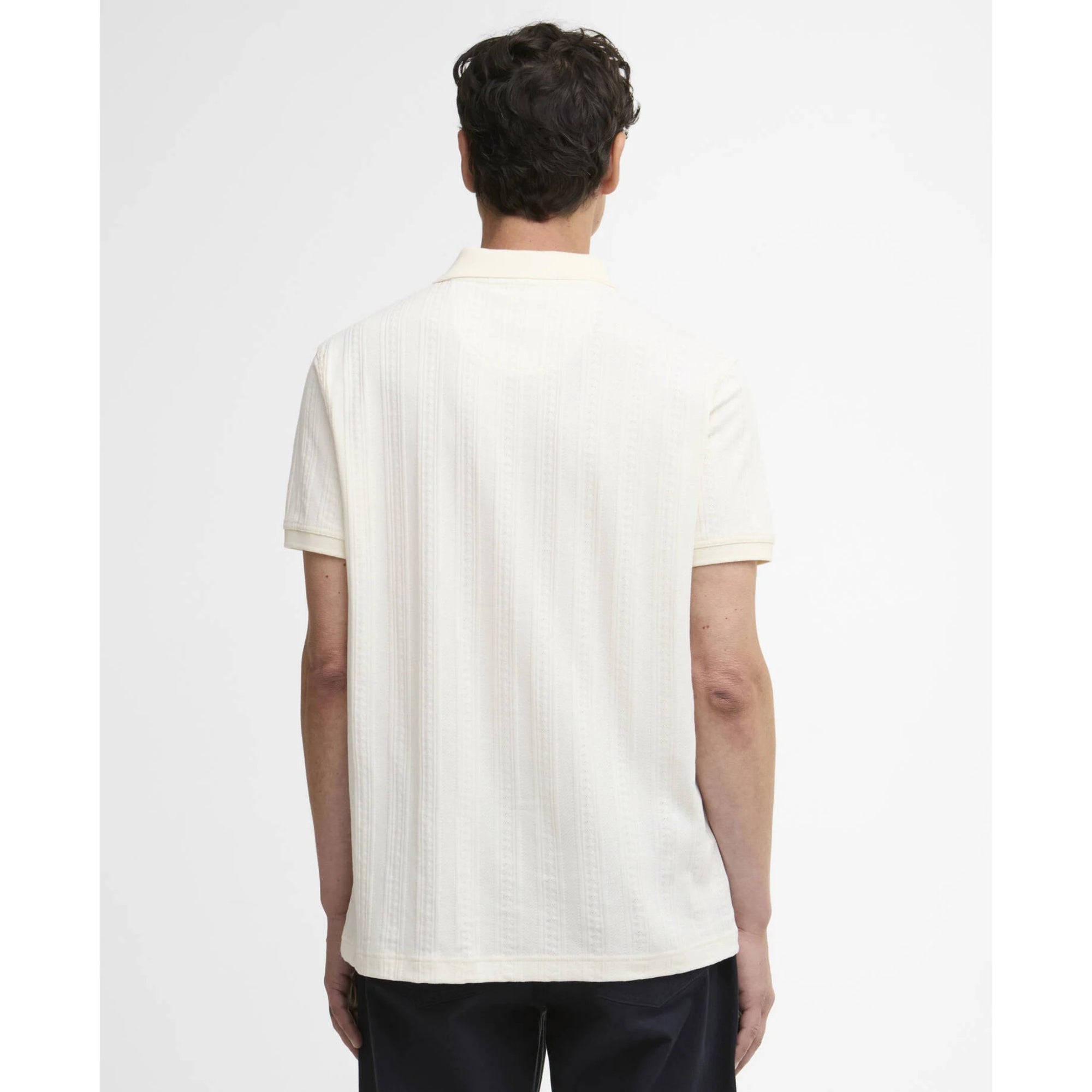 Person wearing a white textured shirt on a plain background