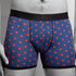 Blue boxer briefs with red heart pattern worn by a person on a gray background
