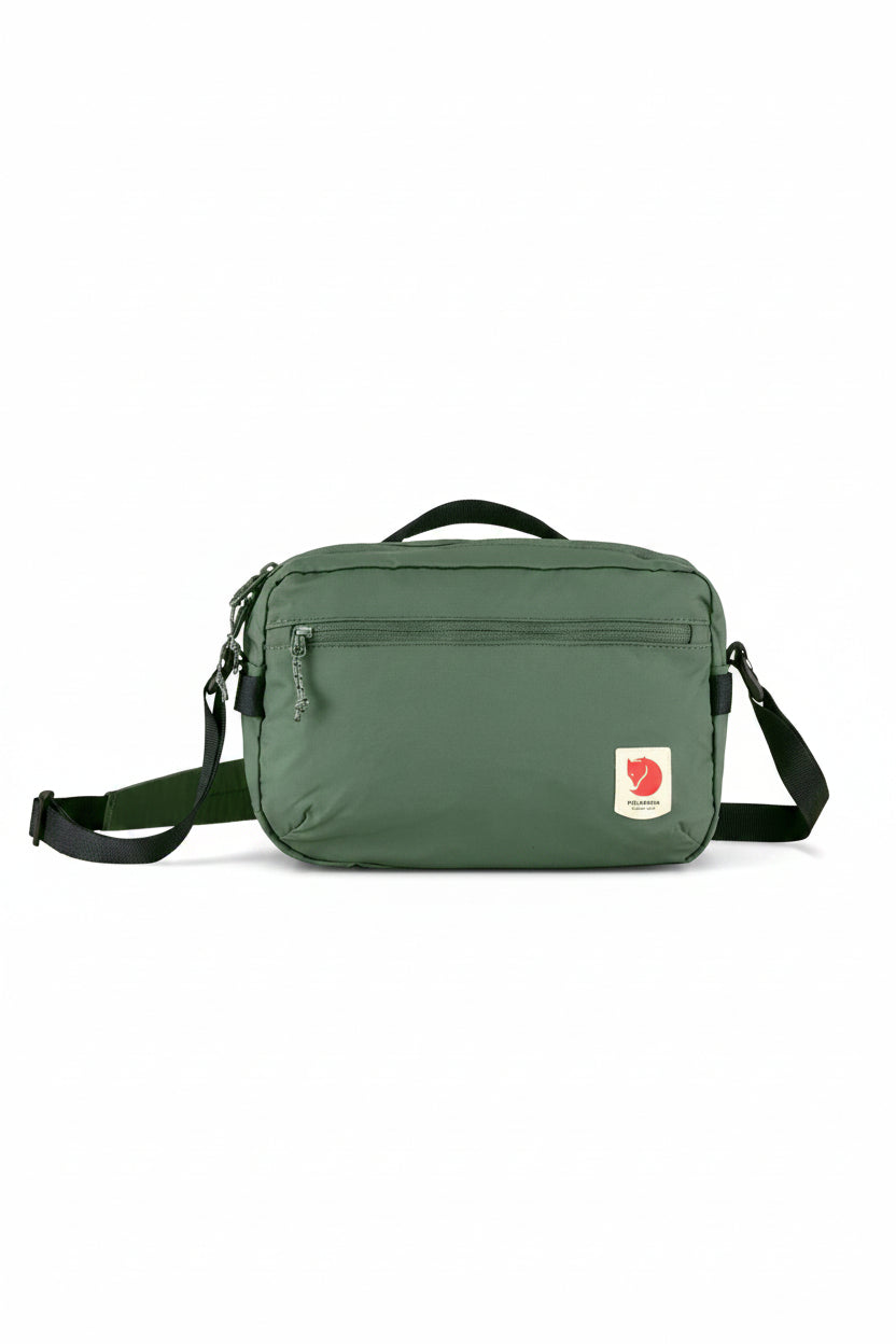 Green shoulder bag with a visible brand logo on a white background