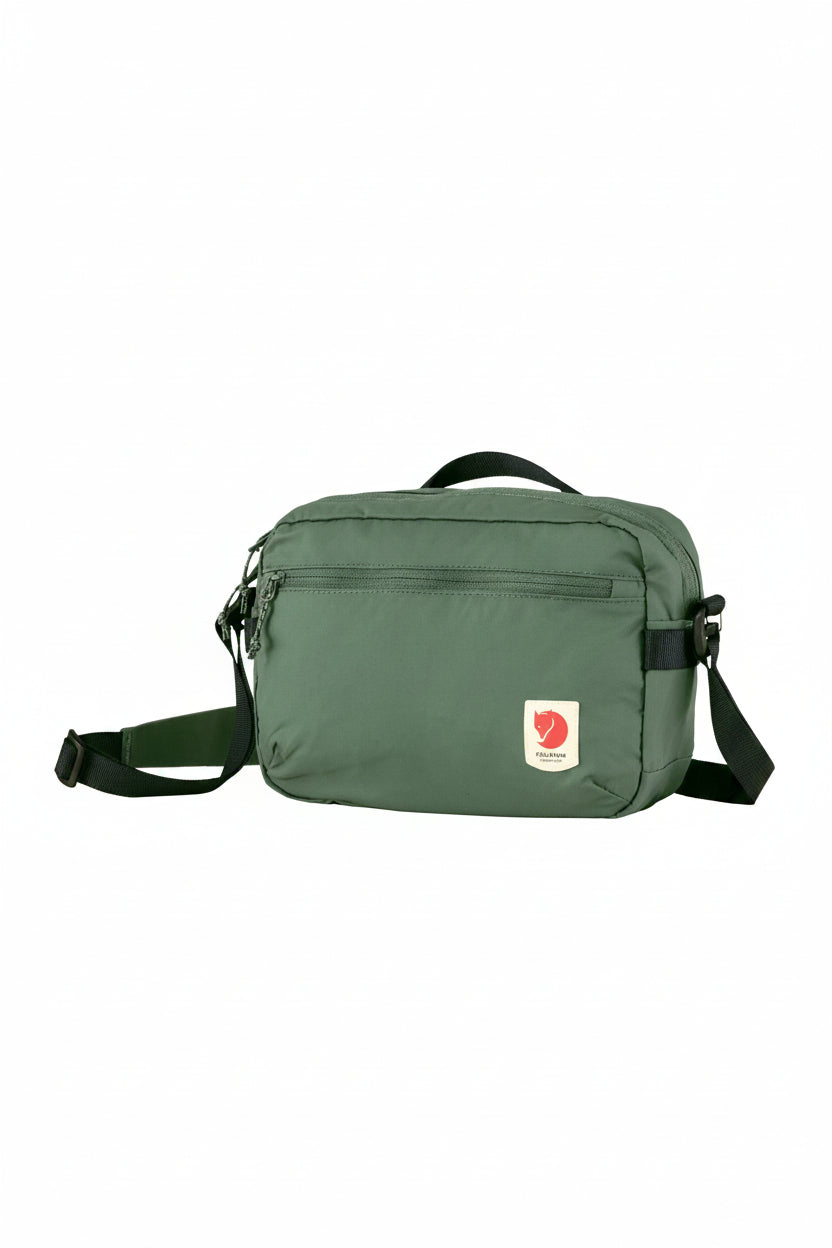 Green shoulder bag with a visible brand logo on a white background