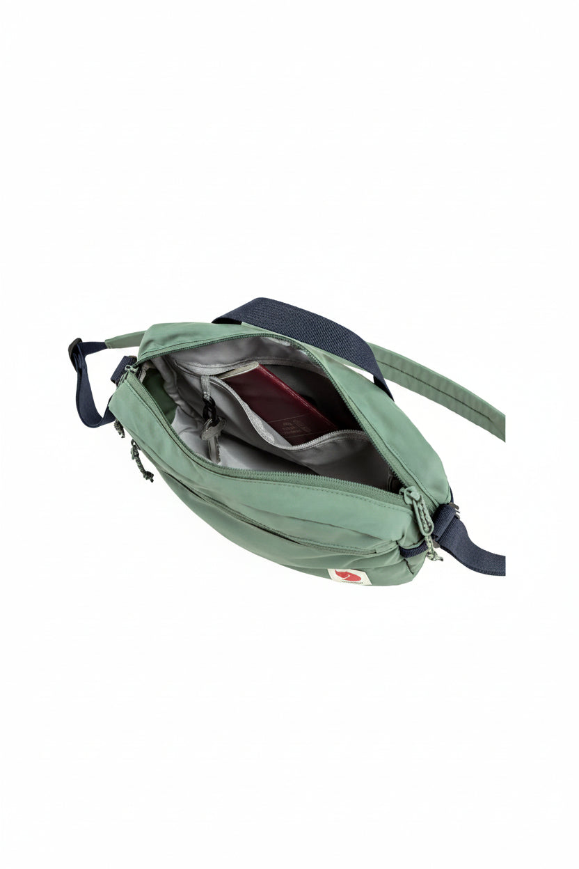 Green waist bag with a visible brand logo on a white background