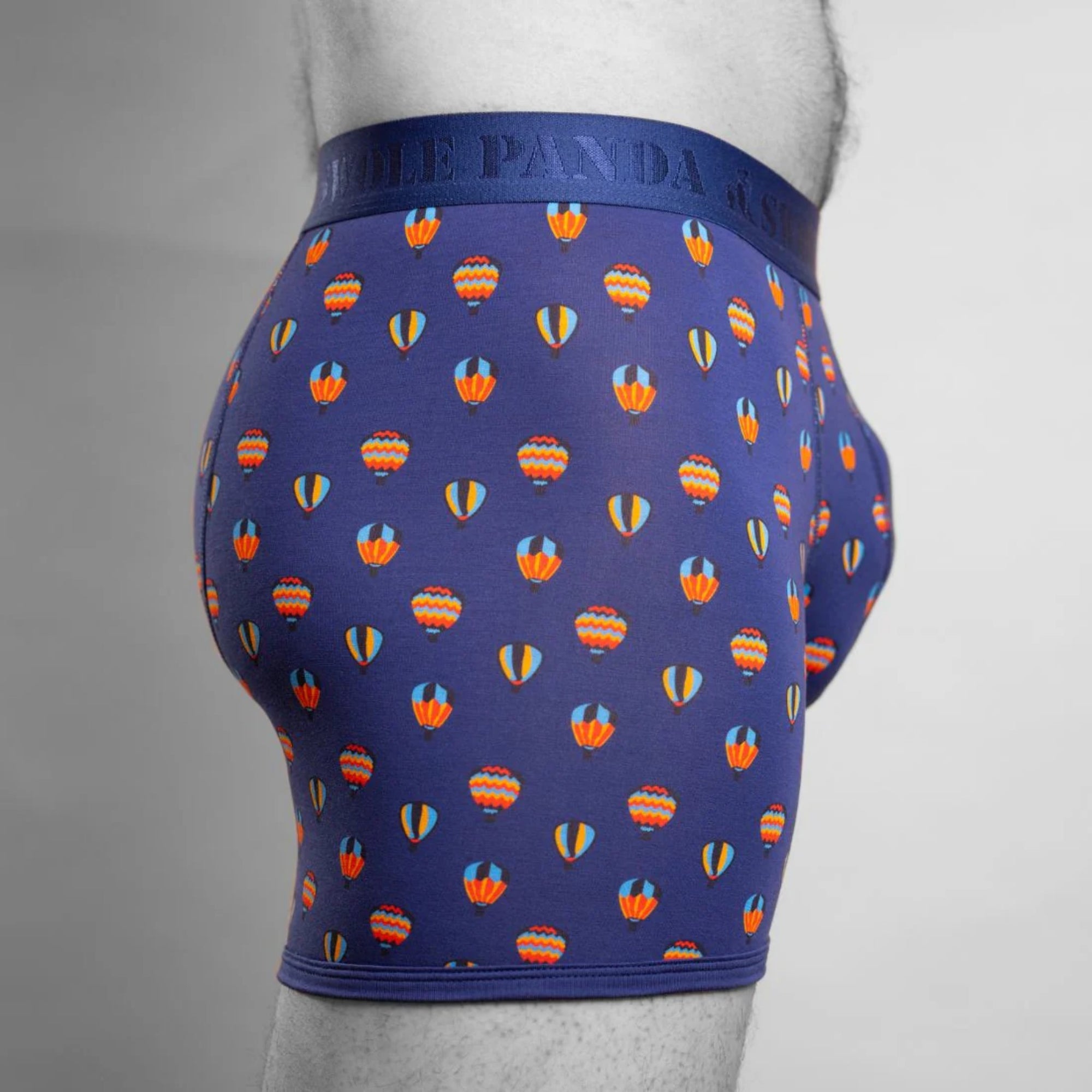 Blue boxer briefs with hot air balloon pattern on a gray background
