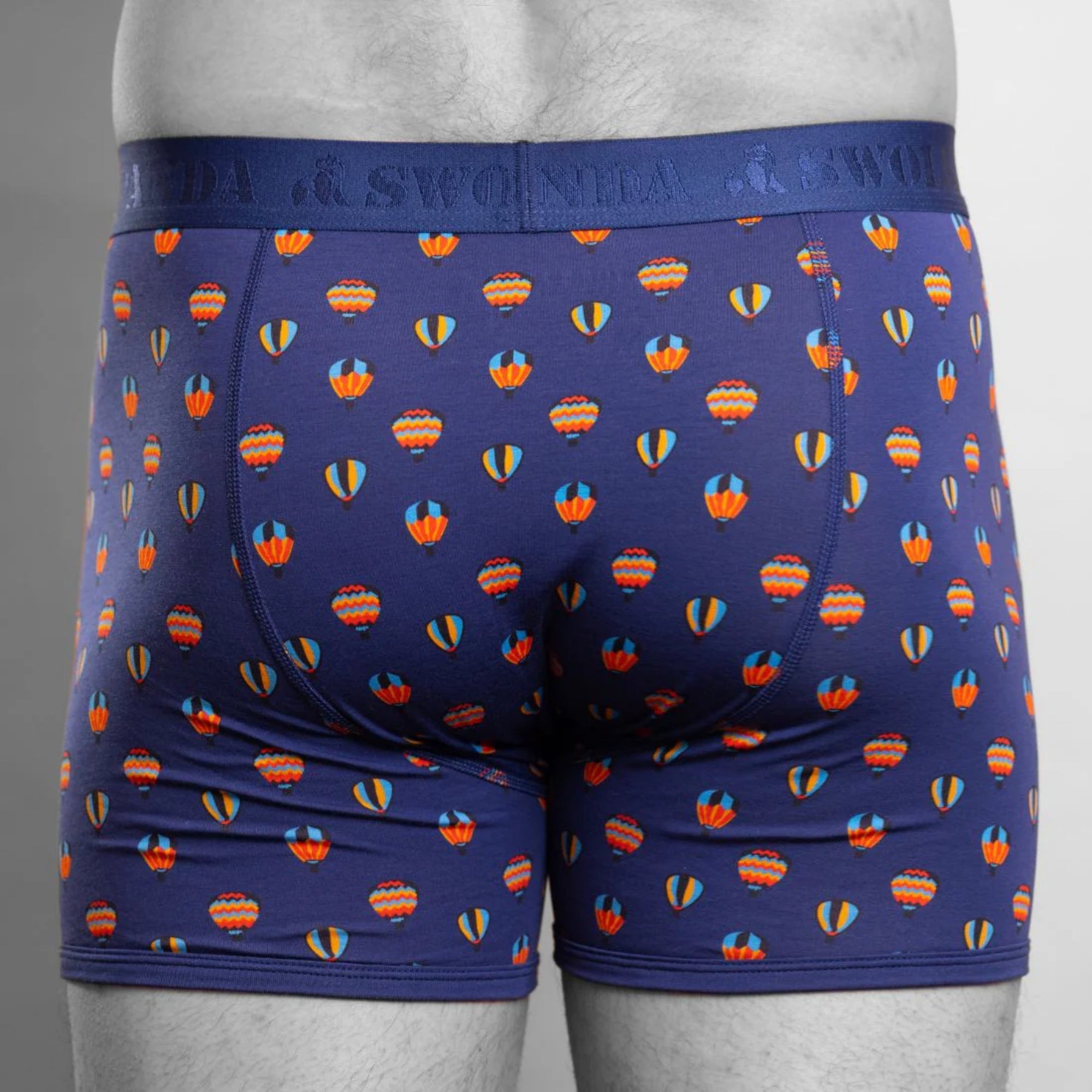 Blue boxer briefs with hot air balloon pattern on a gray background
