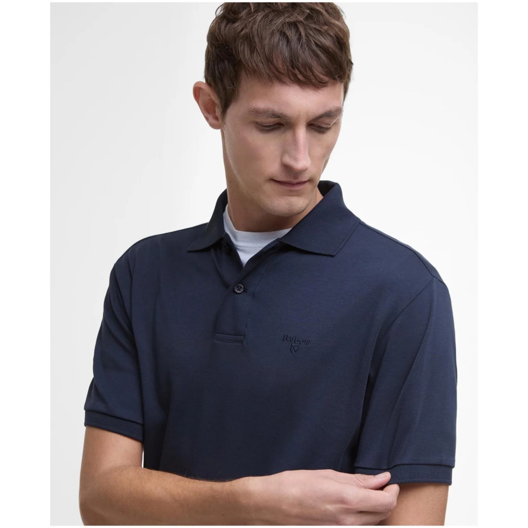 Man wearing a navy blue polo shirt on a white background