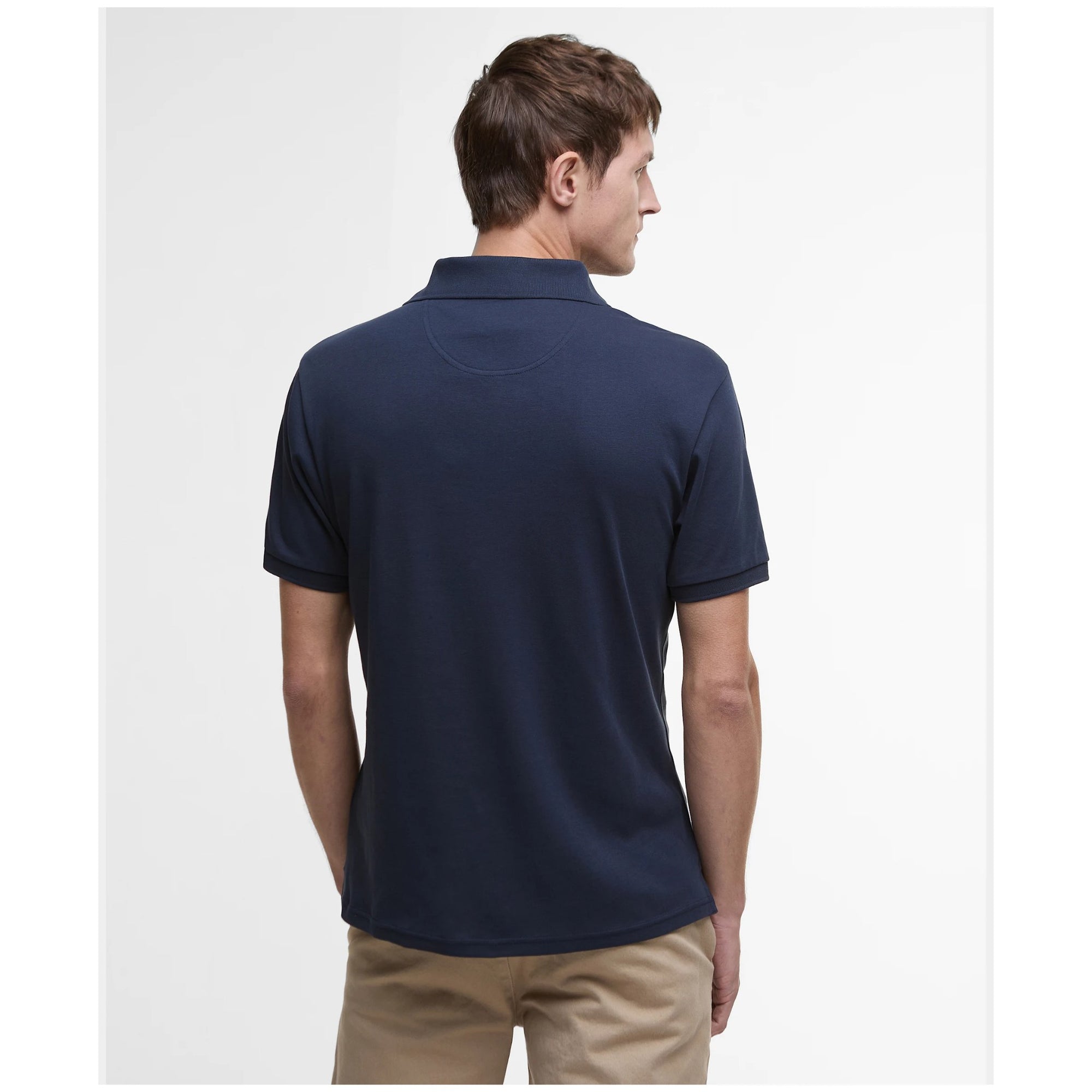 Man wearing a navy blue polo shirt on a white background