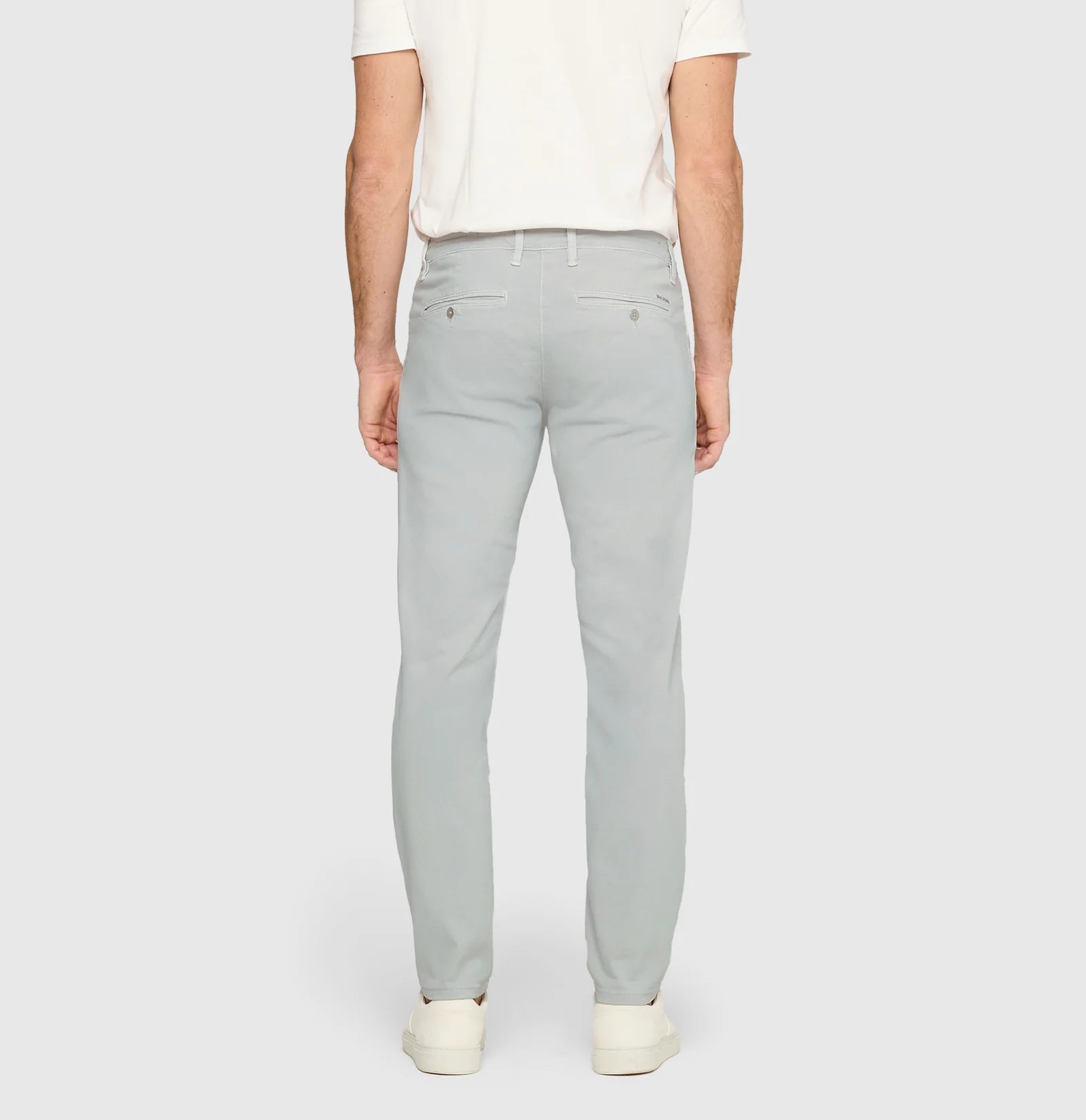 Light gray pants worn by a person on a white background