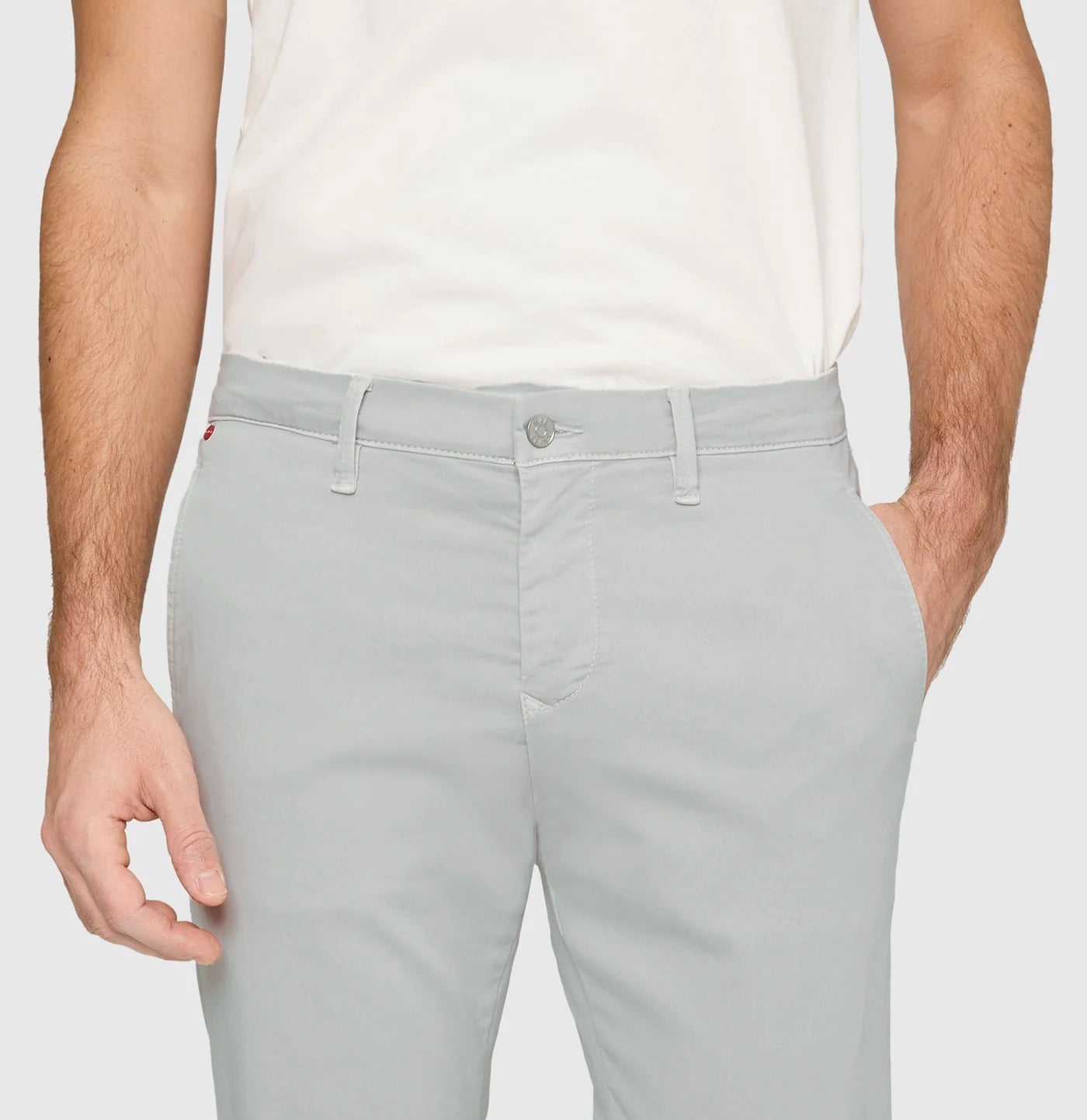 Light gray pants worn by a person on a plain background