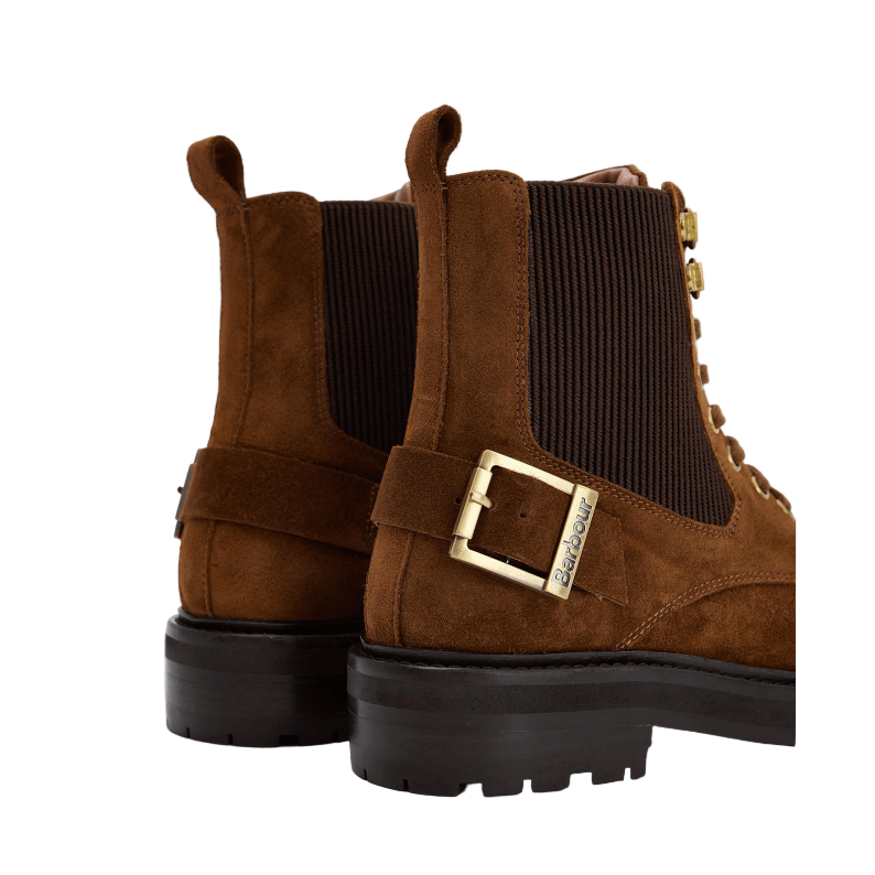 Brown suede boots with a gold buckle on a white background