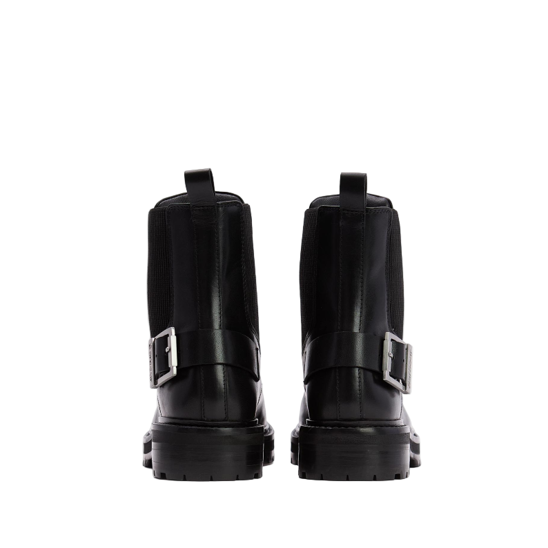 Pair of black leather boots with buckles on a white background
