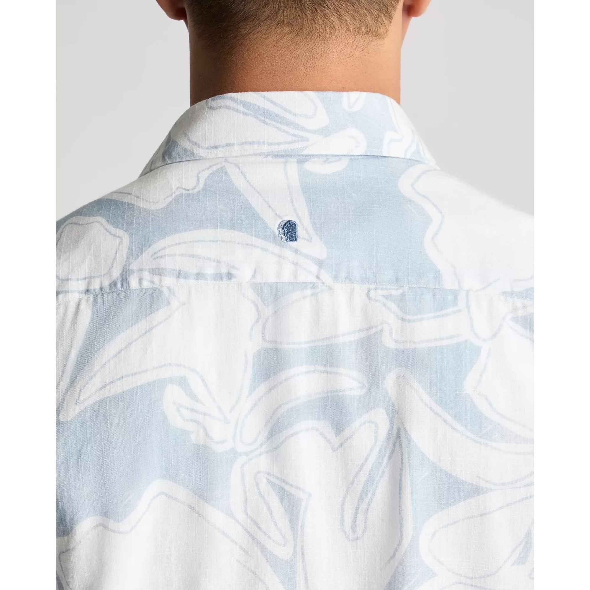 Light blue shirt with white abstract pattern worn by a person