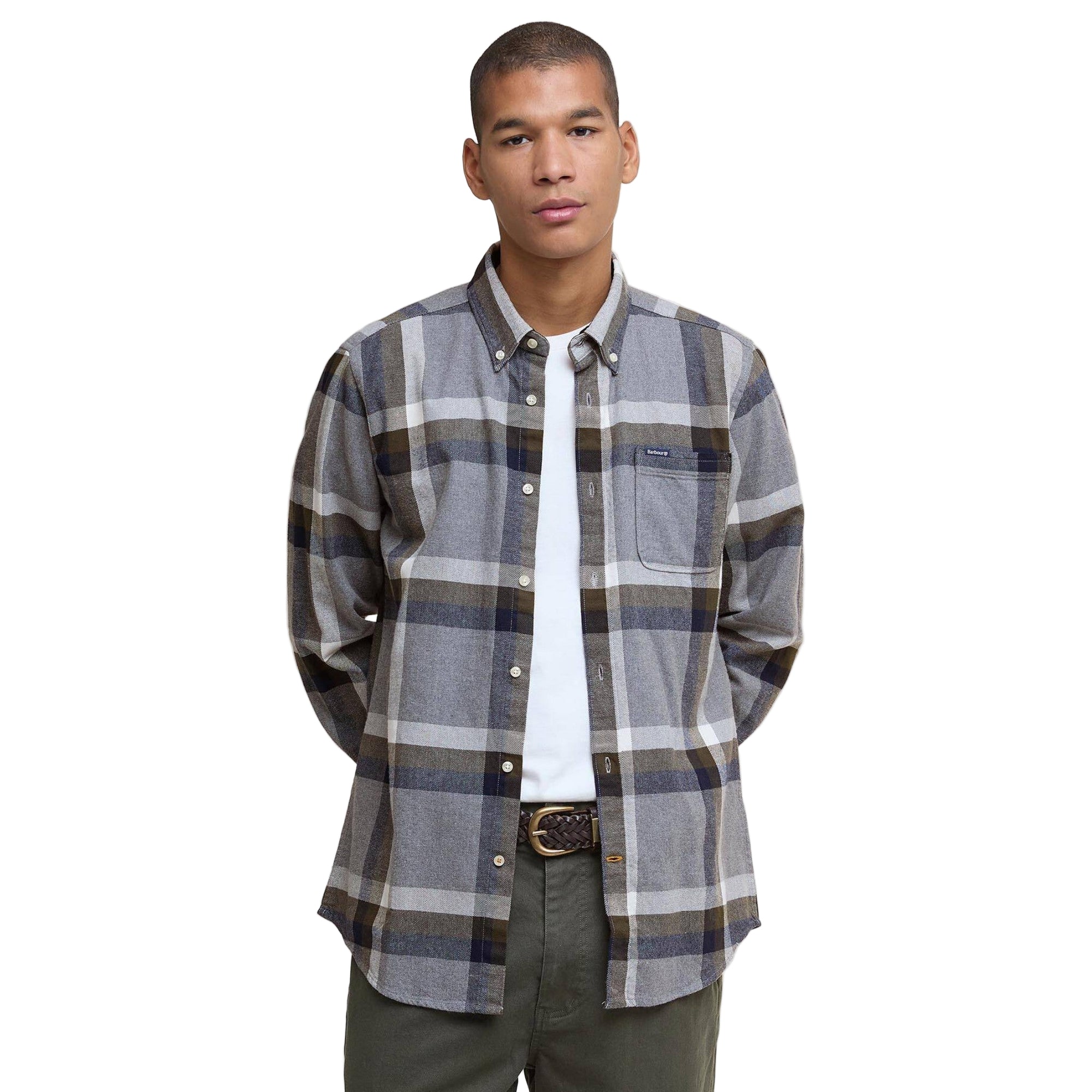 Man wearing a plaid shirt over a white shirt on a plain background
