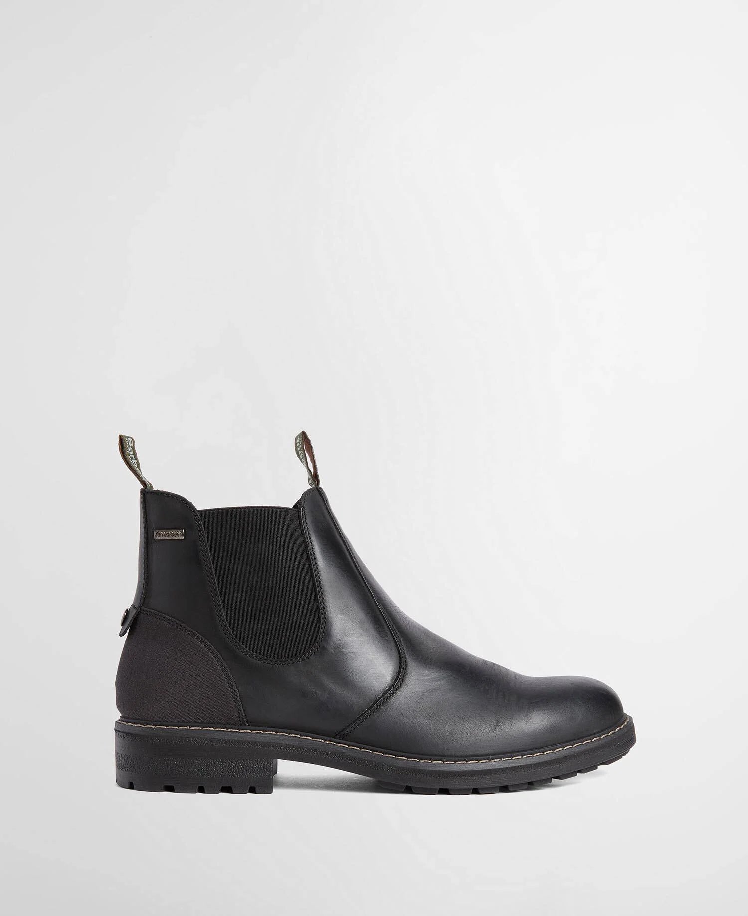 A black Barbour leather Chelsea-style ankle boot with elastic side gore, a black sole, and bright red pull loops at the top, shown in a side profile on a light gray background.