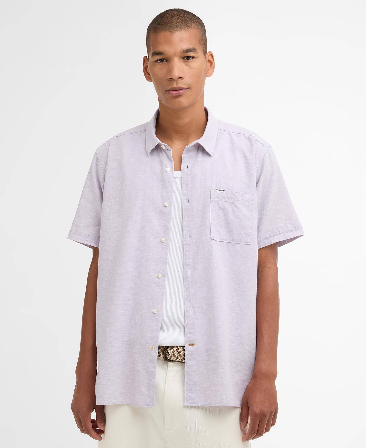 Man wearing a light purple short-sleeve shirt on a white background