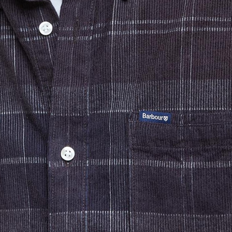 Man wearing a Barbour plaid shirt close up of Barbour logo