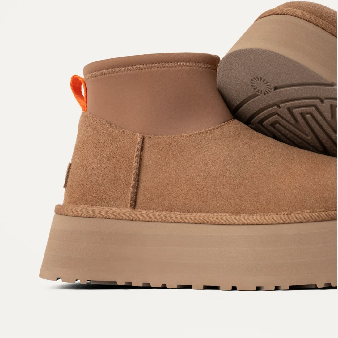 A chestnut brown UGG Classic Mini Dipper boot with a short neoprene shaft, suede upper, and a thick platform sole.