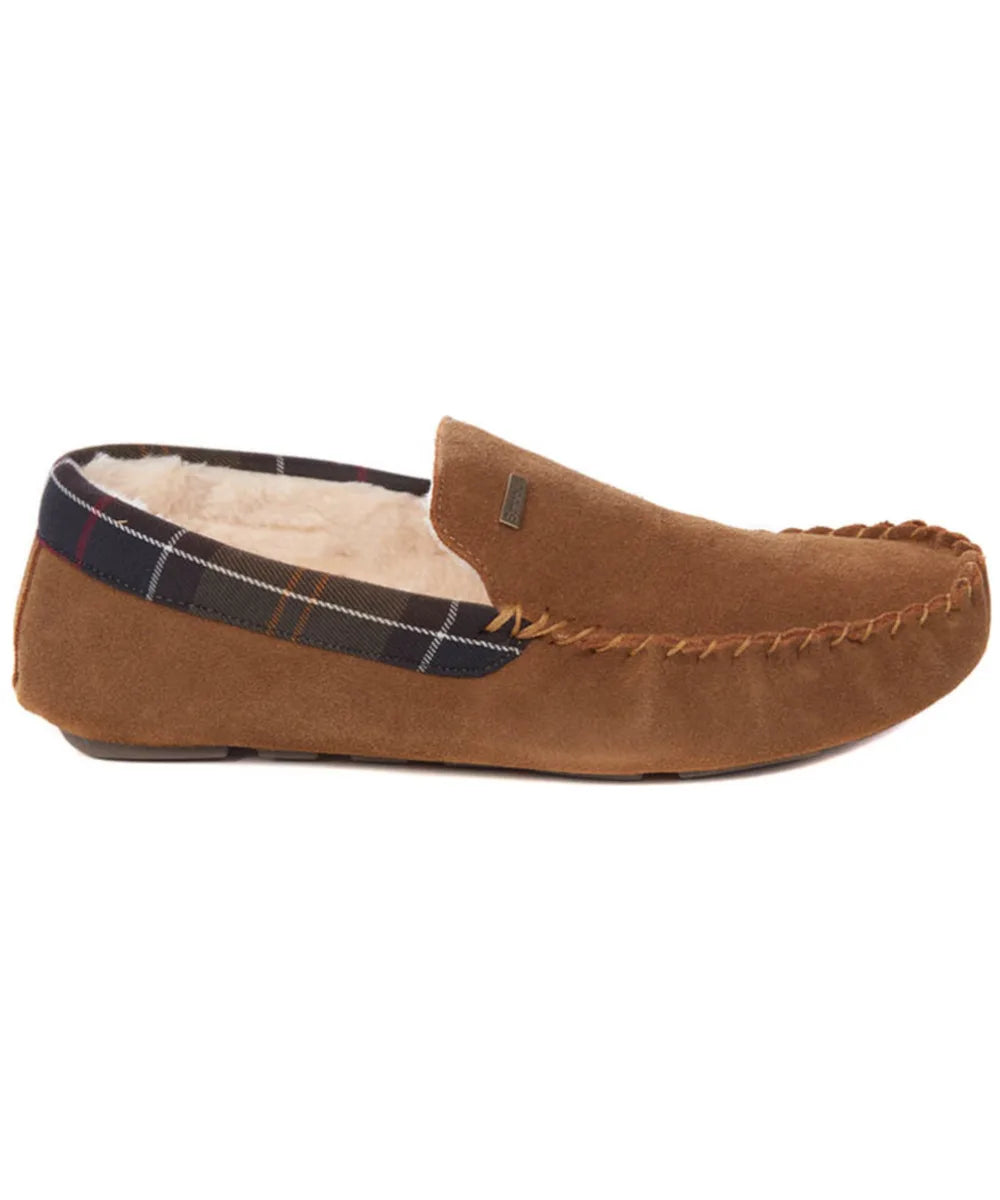 A brown suede slip-on moccasin-style loafer from Barbour with a soft cream sherpa lining and a navy plaid trim along the inner edge, shown against a plain white background.