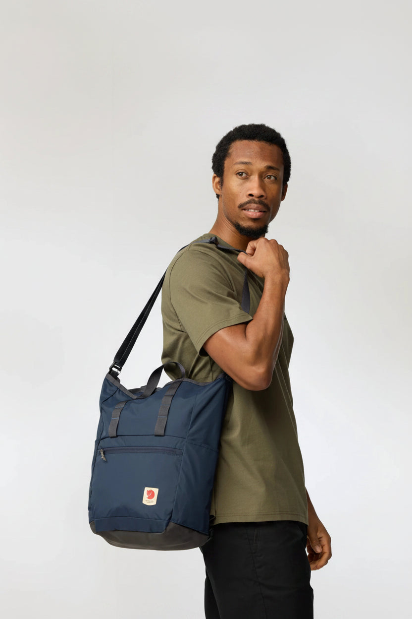 Man carrying a blue bag on a white background