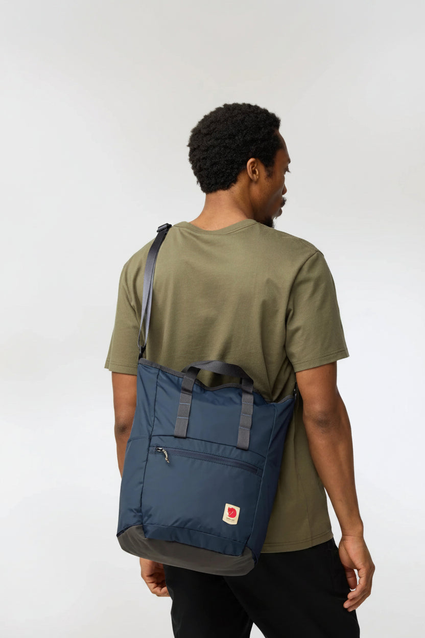 Person wearing a blue backpack on a white background
