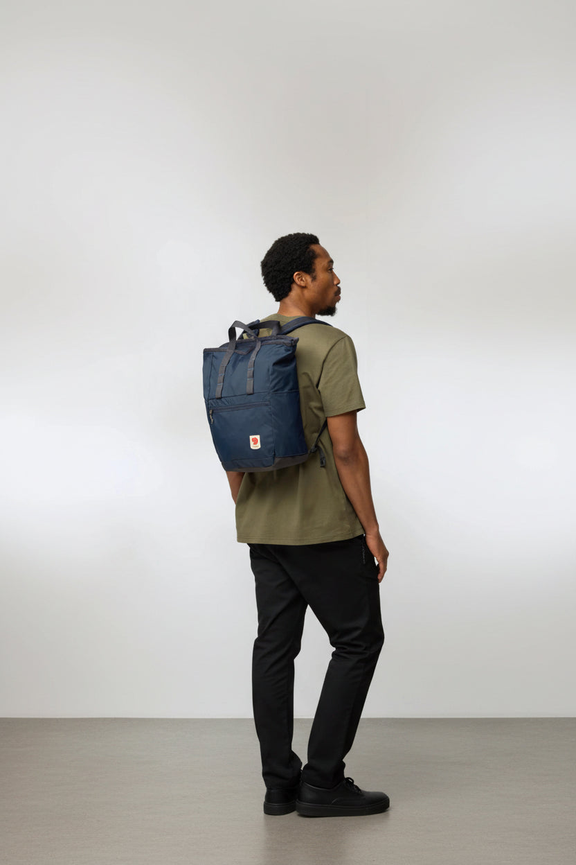 Man wearing a blue backpack on a white background