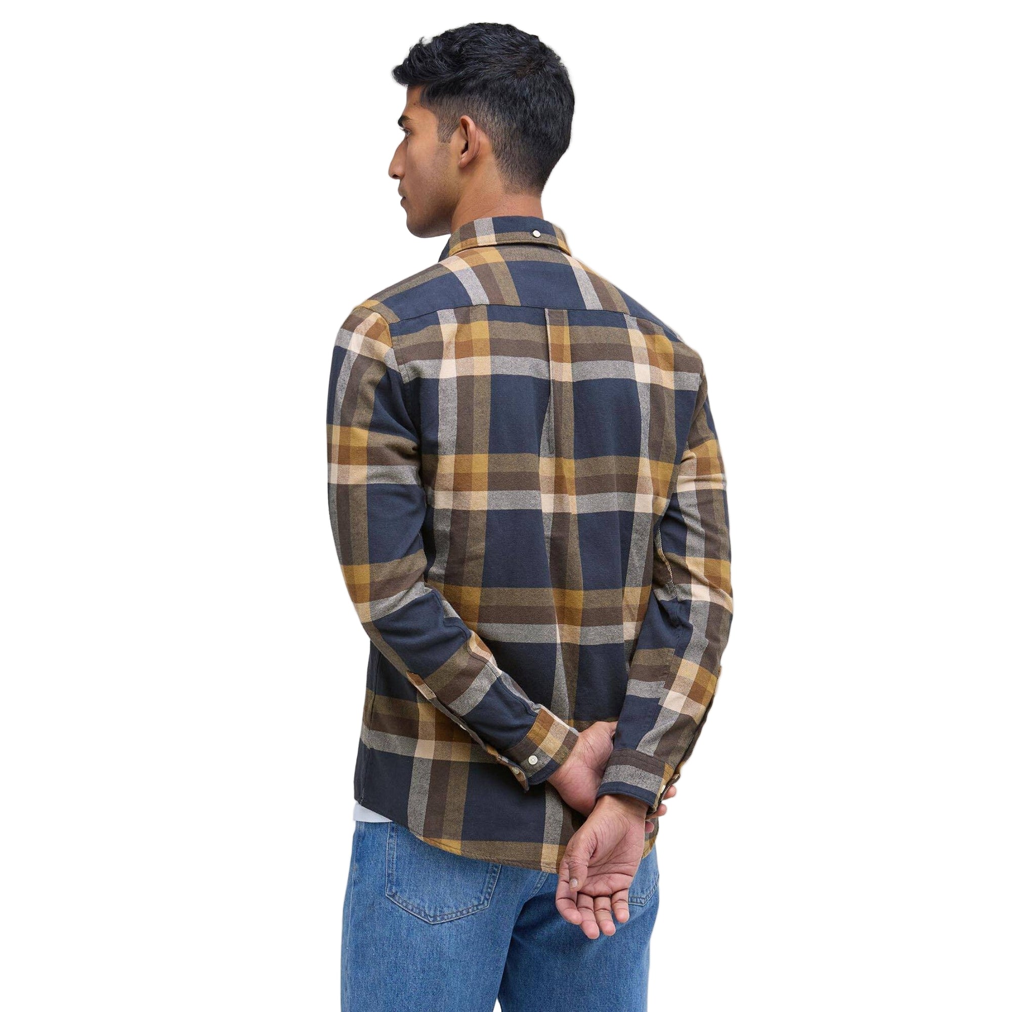 Man wearing a plaid shirt and jeans on a white background