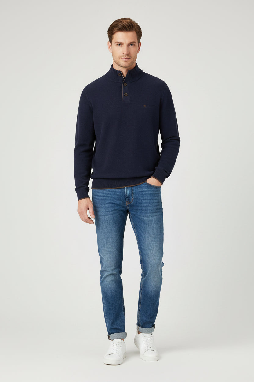 Navy blue sweater with button details on a white background