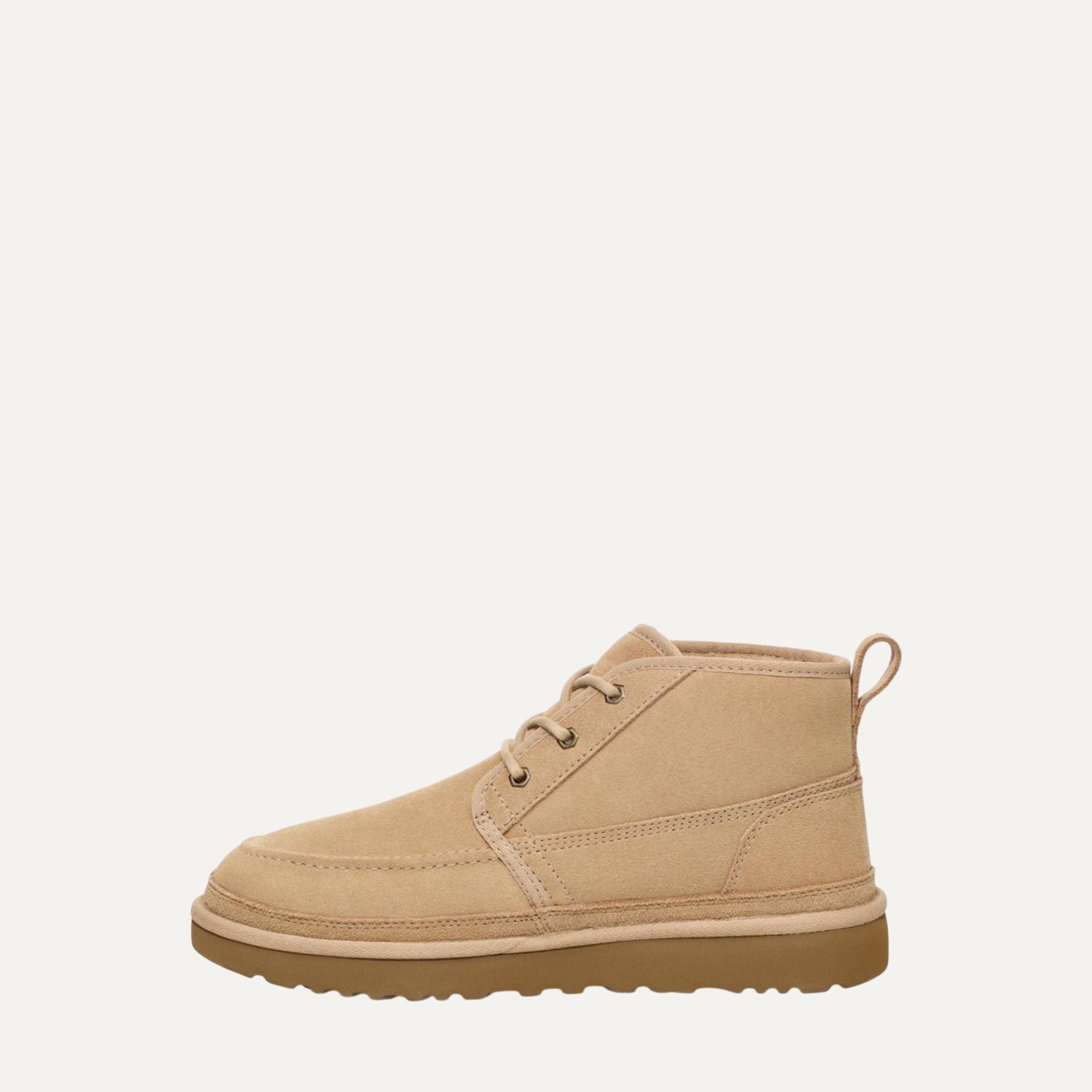 Tan ankle boot on a light beige background